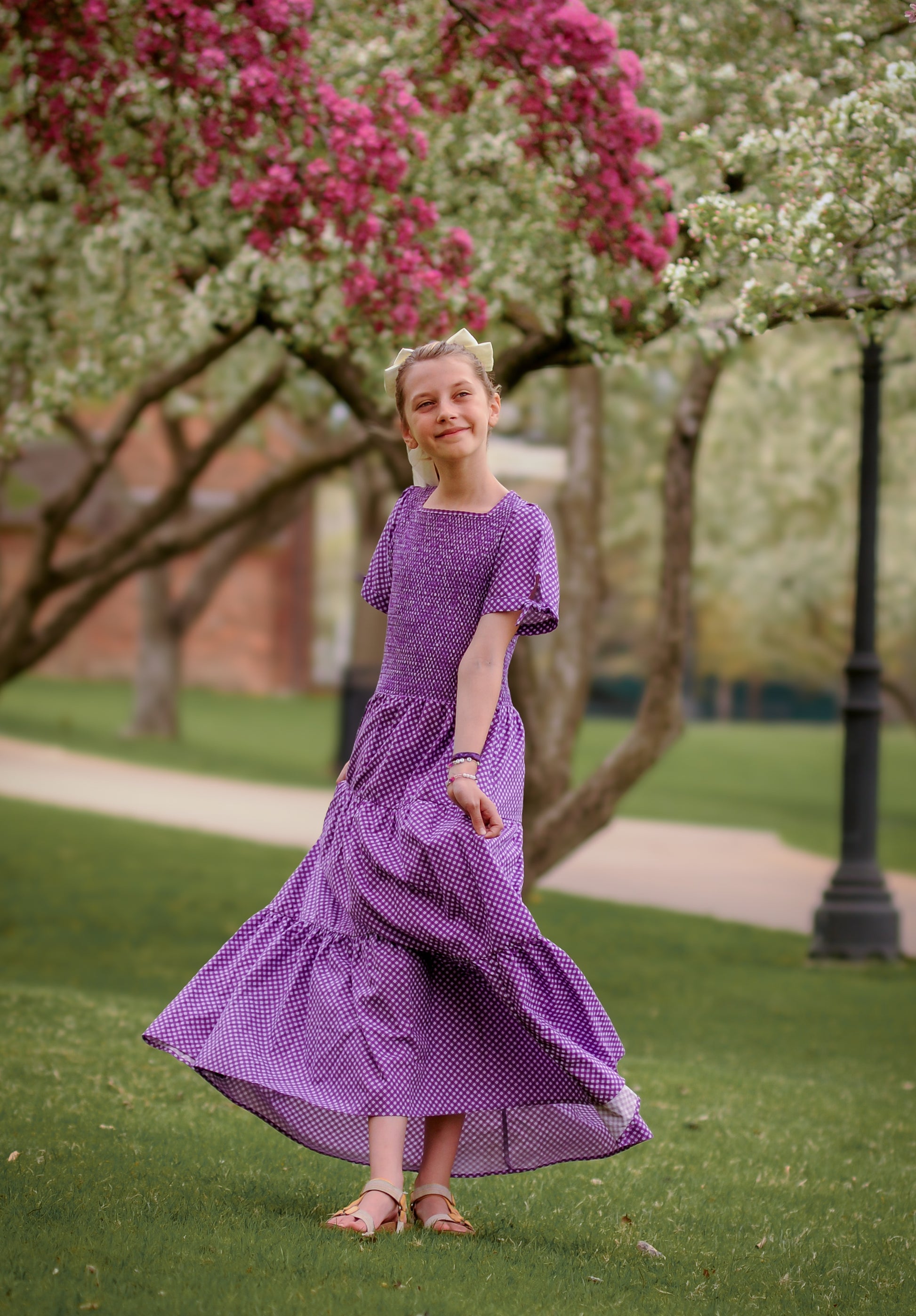 Young girl wearing a modest purple dress