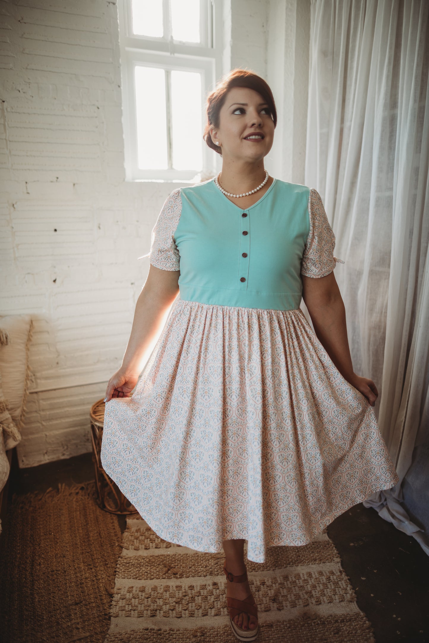 A woman wearing a vintage style modest nursing dress.