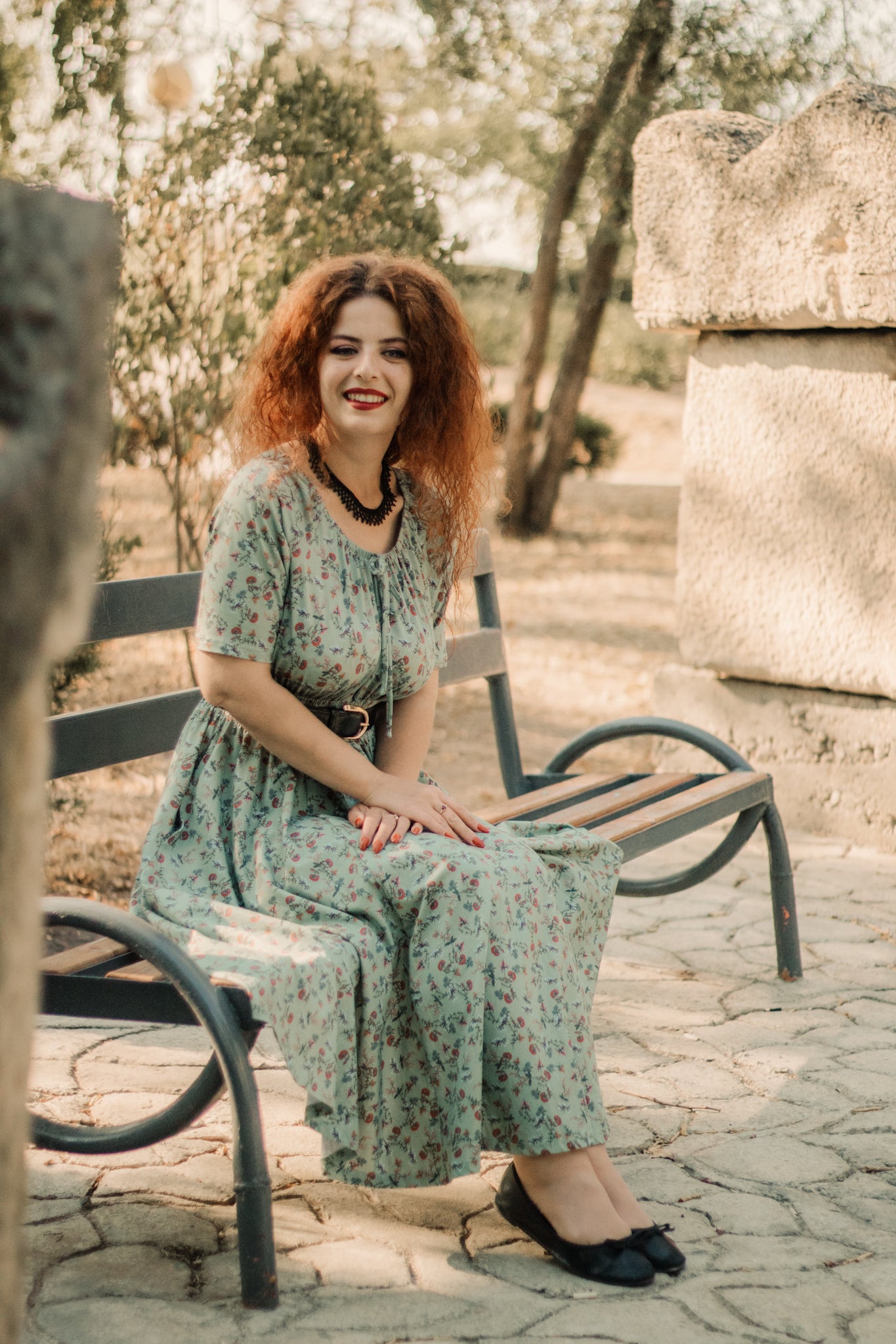 Woman in modest nursing dress on bench