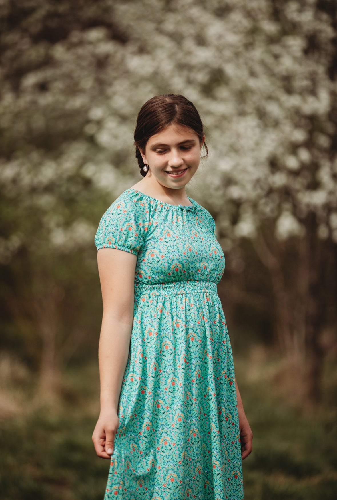 Young girl wearing a modest green dress