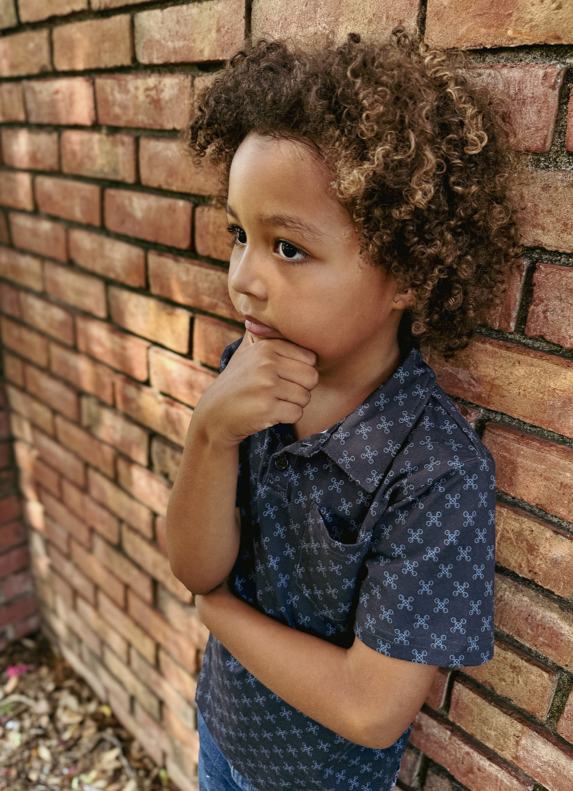 Young boy wearing a dark blue polo shirt
