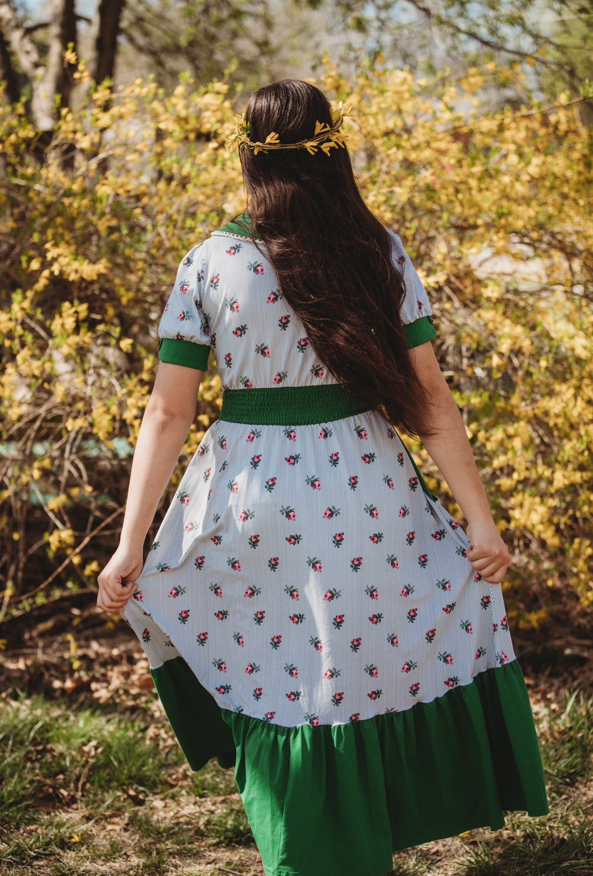 woman wearing a green and white striped modest nursing dress