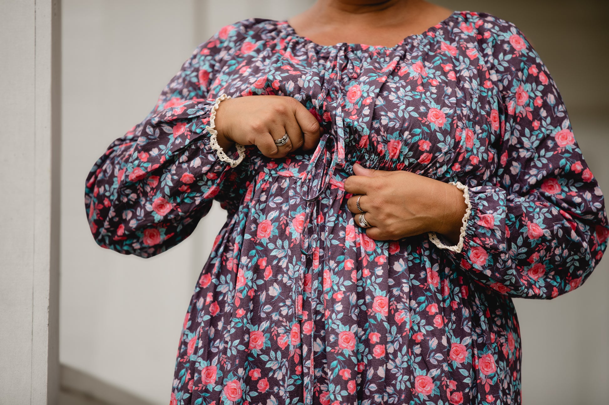 Woman in modest nursing floral dress pose