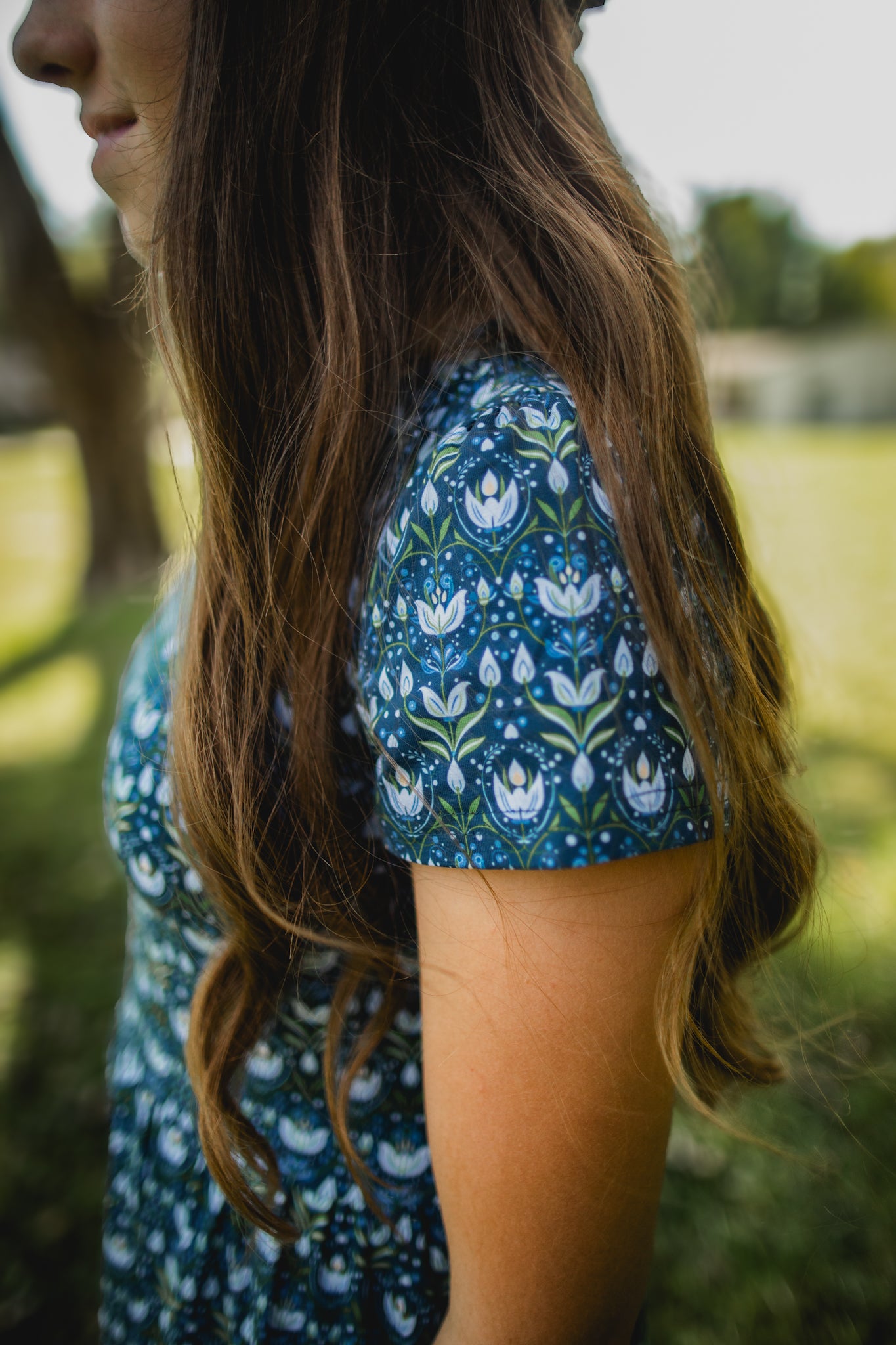 Woman in modest nursing blue floral dress outdoors