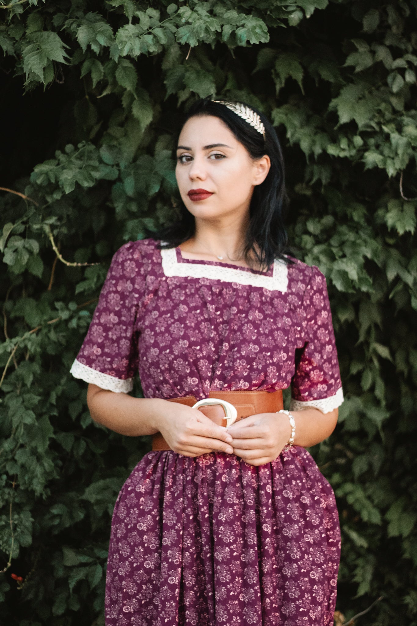 Woman in modest purple nursing dress outdoors