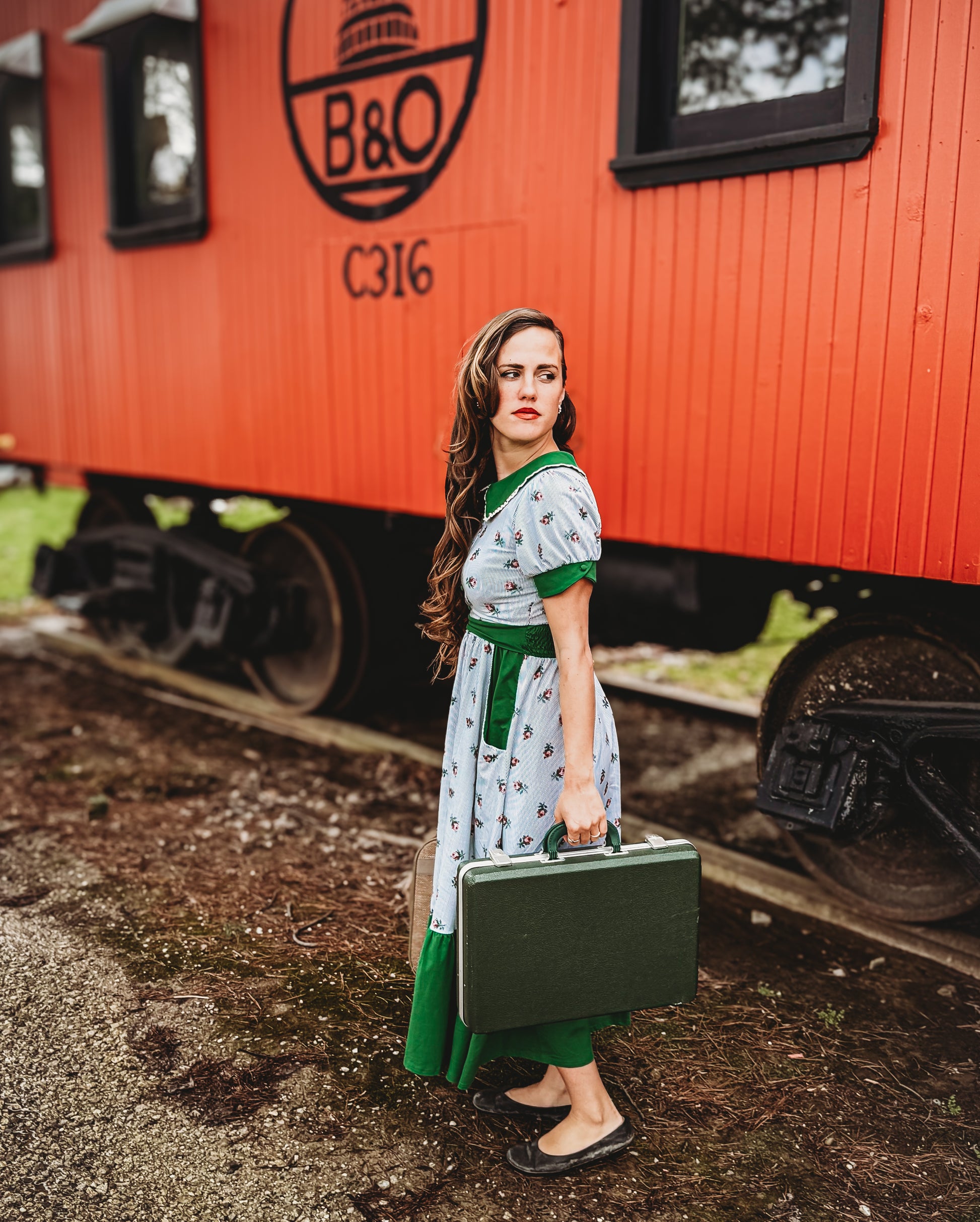 woman wearing a green and white striped modest nursing dress