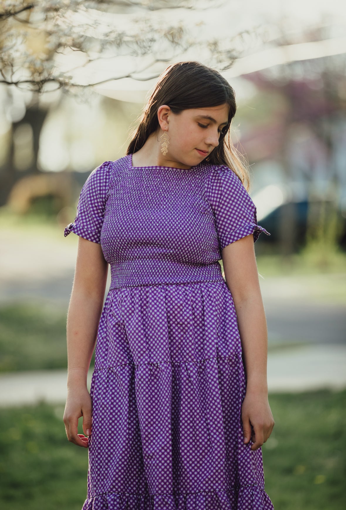 Young girl wearing a modest purple dress