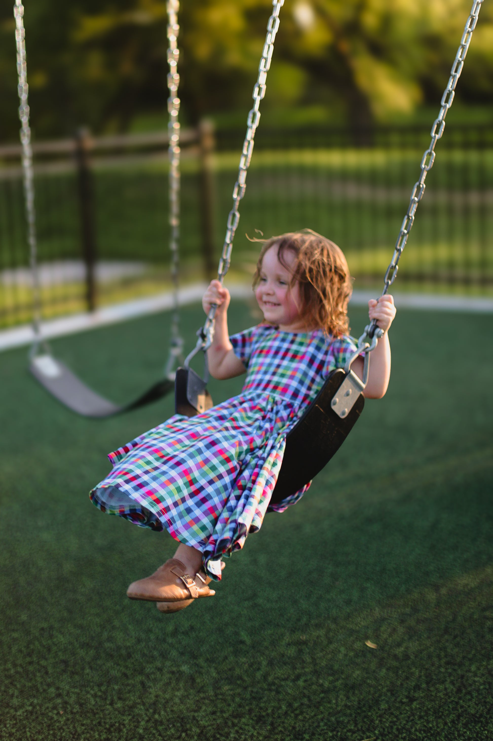 Young girl in a colorful checkered modest dress
