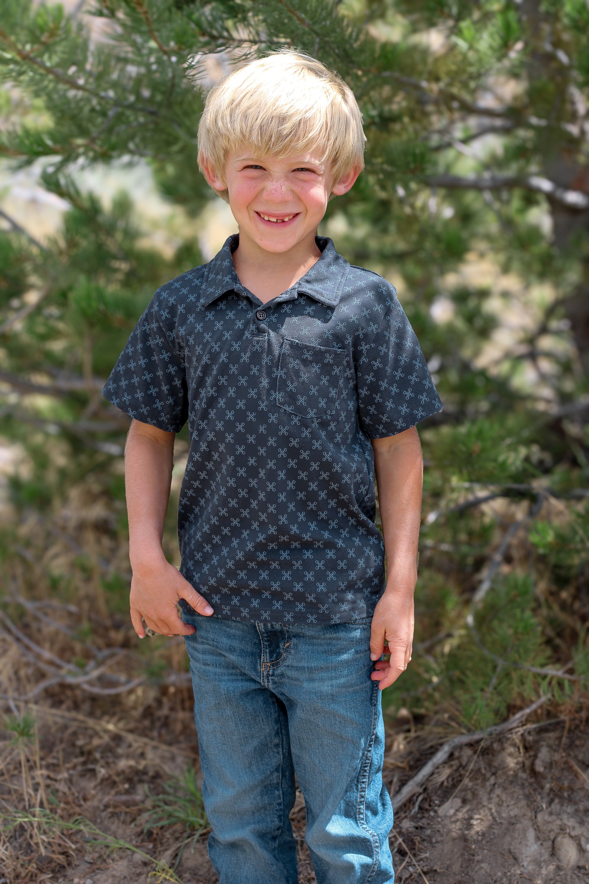 Young boy wearing a dark blue polo shirt