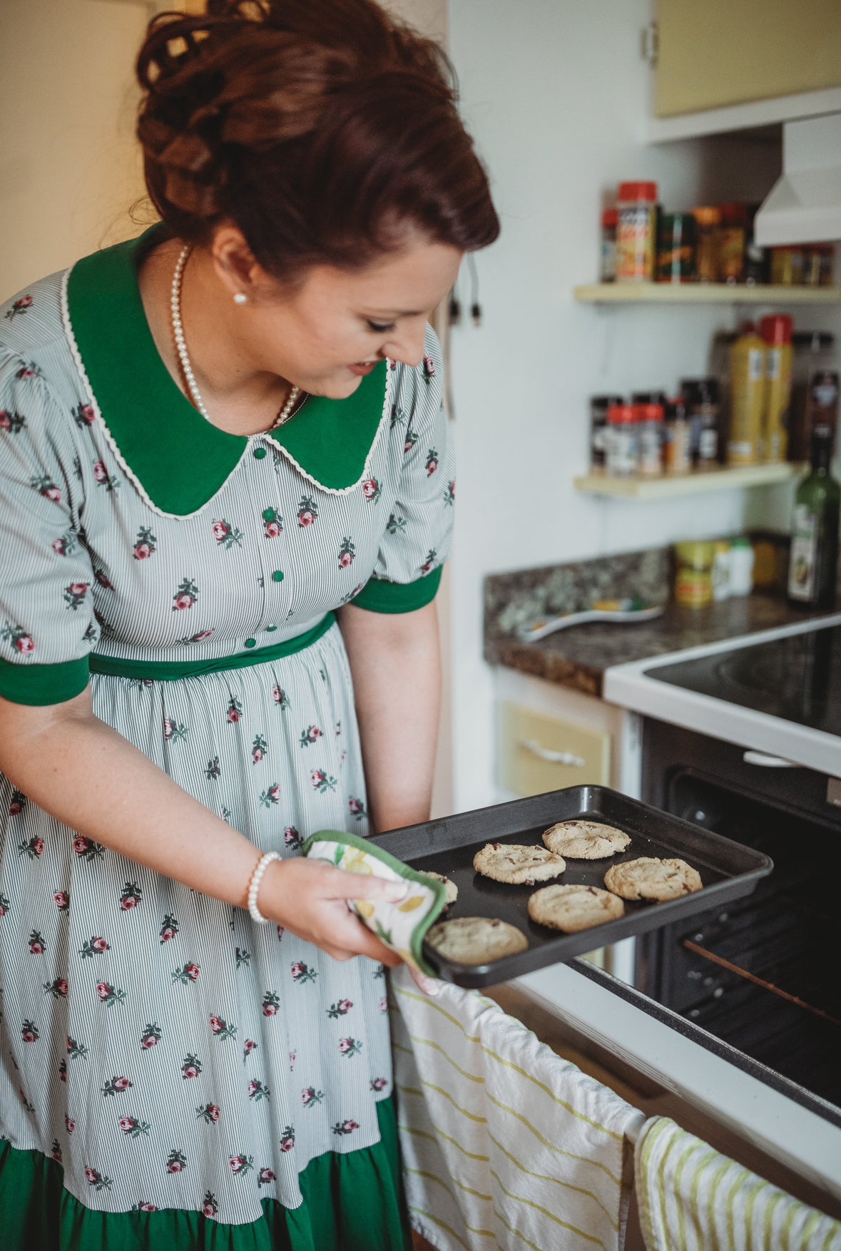 woman wearing a green and white striped modest nursing dress