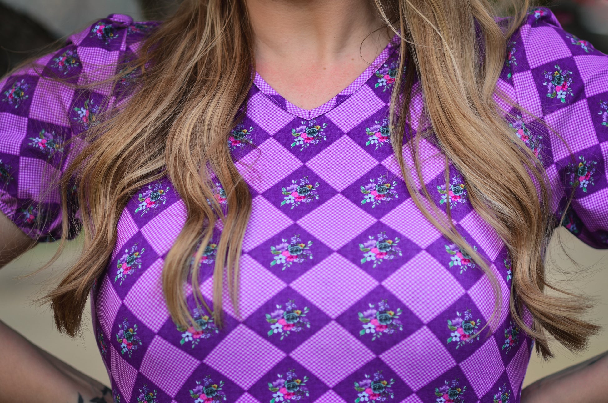 Woman in a purple checkered modest nursing dress.