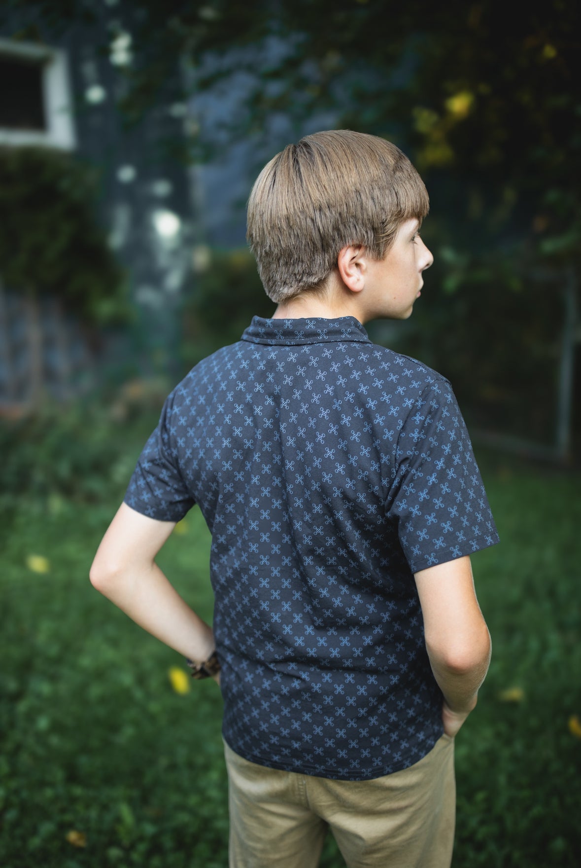 Young boy wearing a dark blue polo shirt