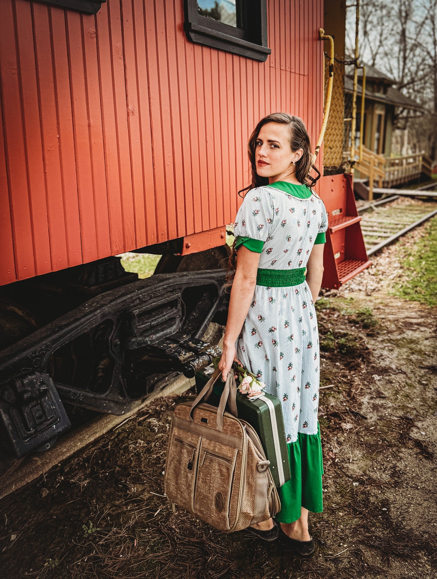 woman wearing a green and white striped modest nursing dress