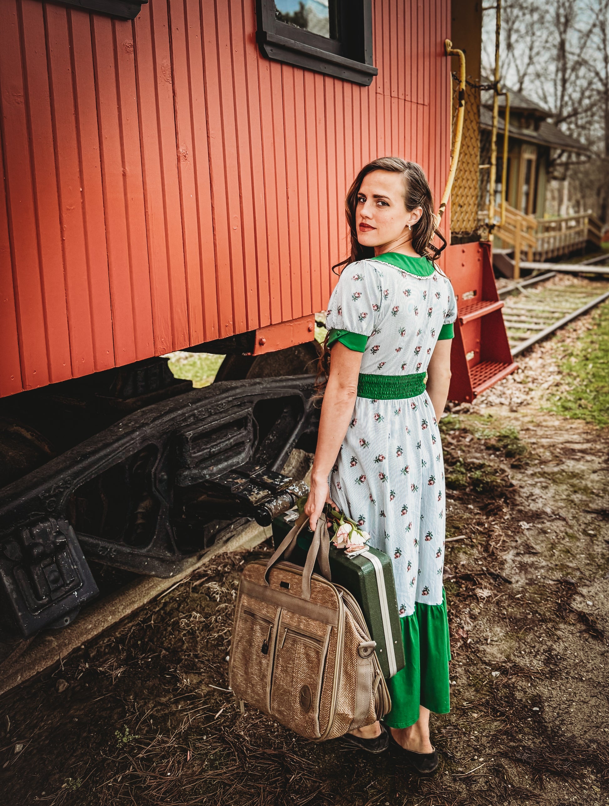 woman wearing a green and white striped modest nursing dress