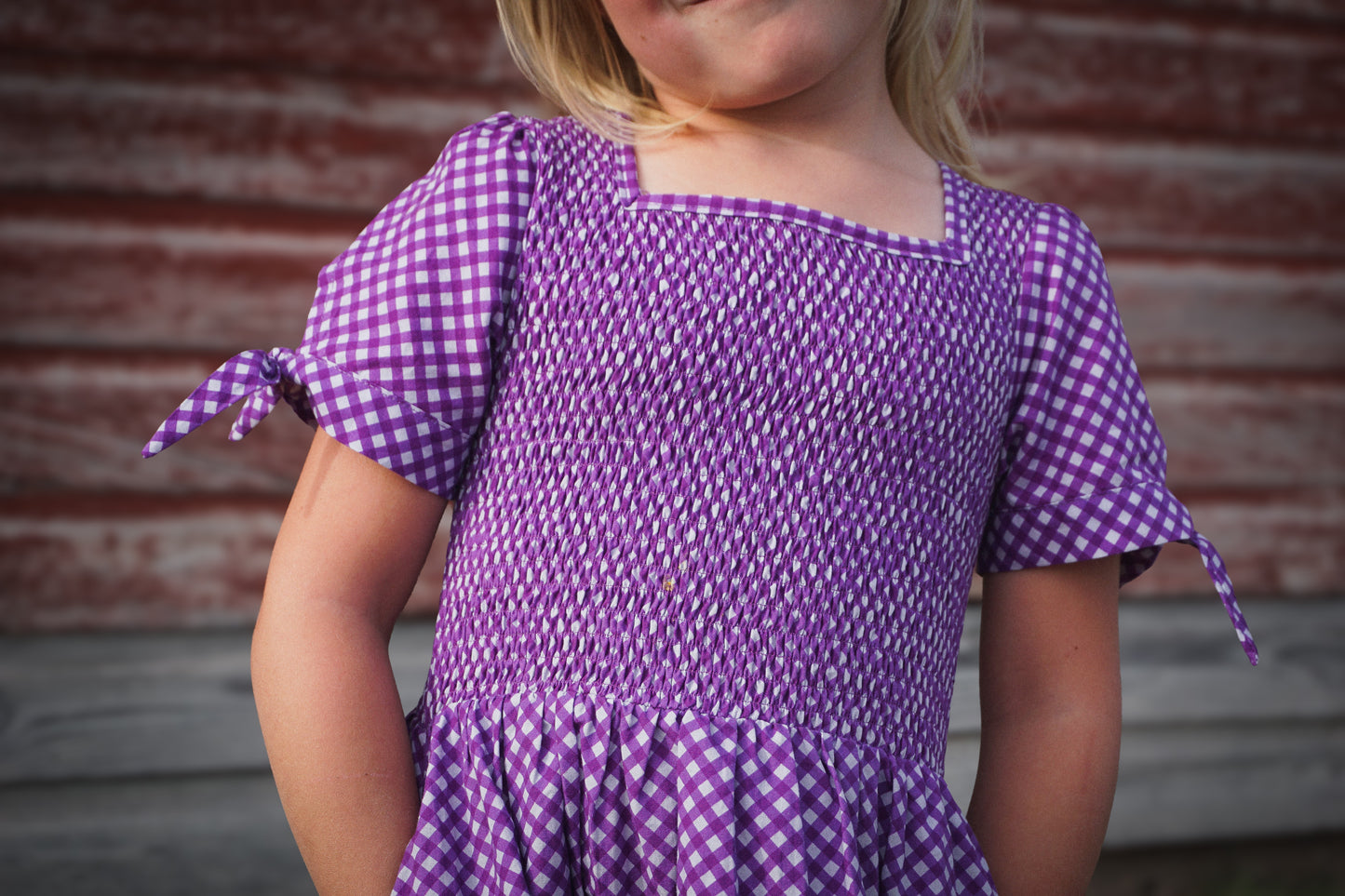 Young girl wearing a modest purple dress