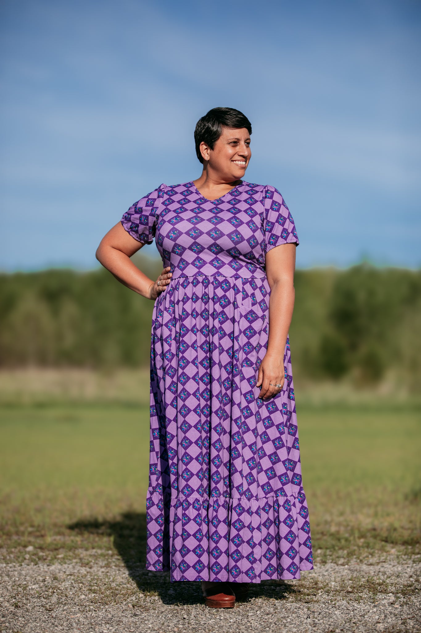 Woman in a purple checkered modest nursing dress.