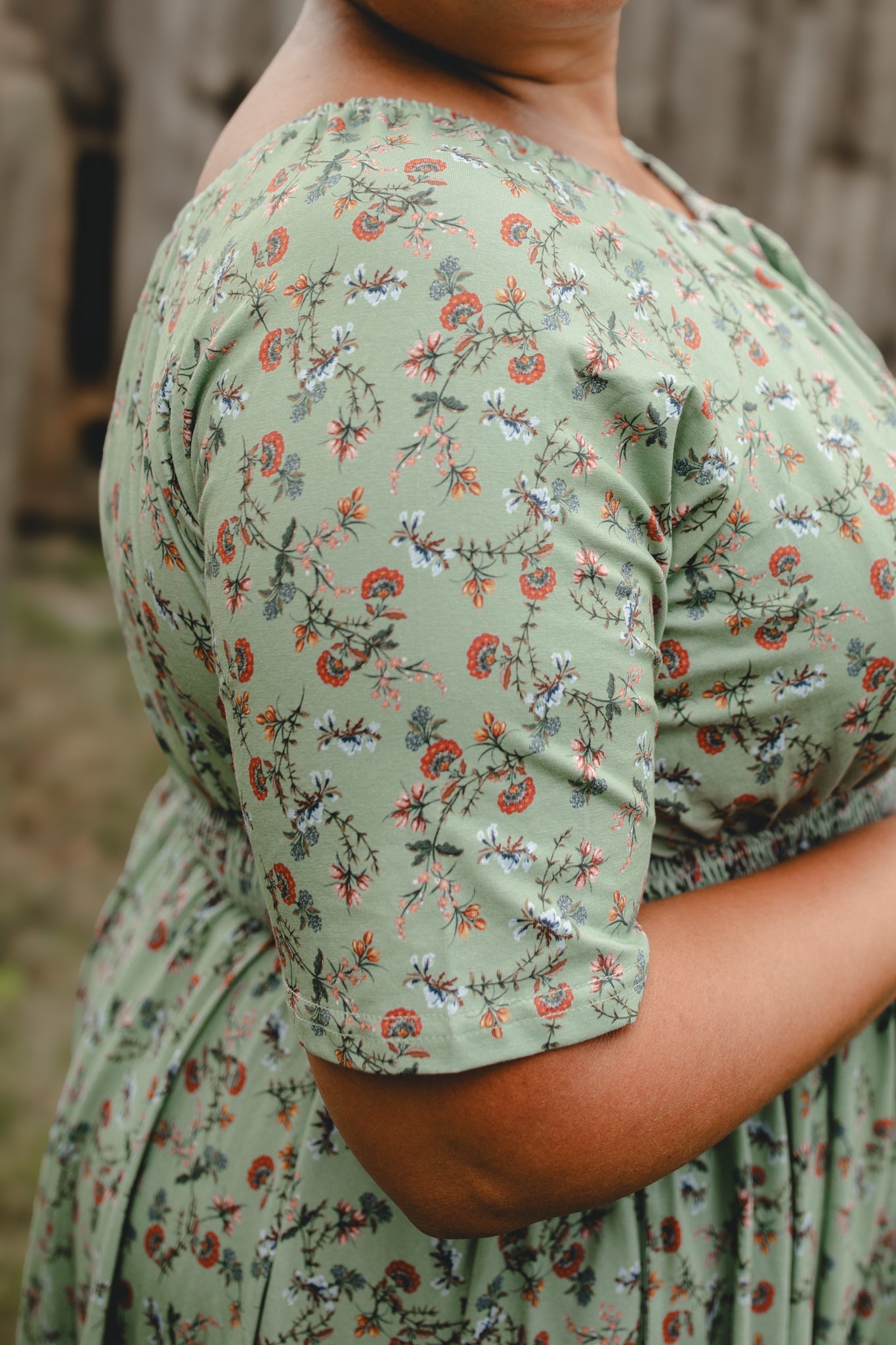 Woman in modest nursing floral dress outdoors