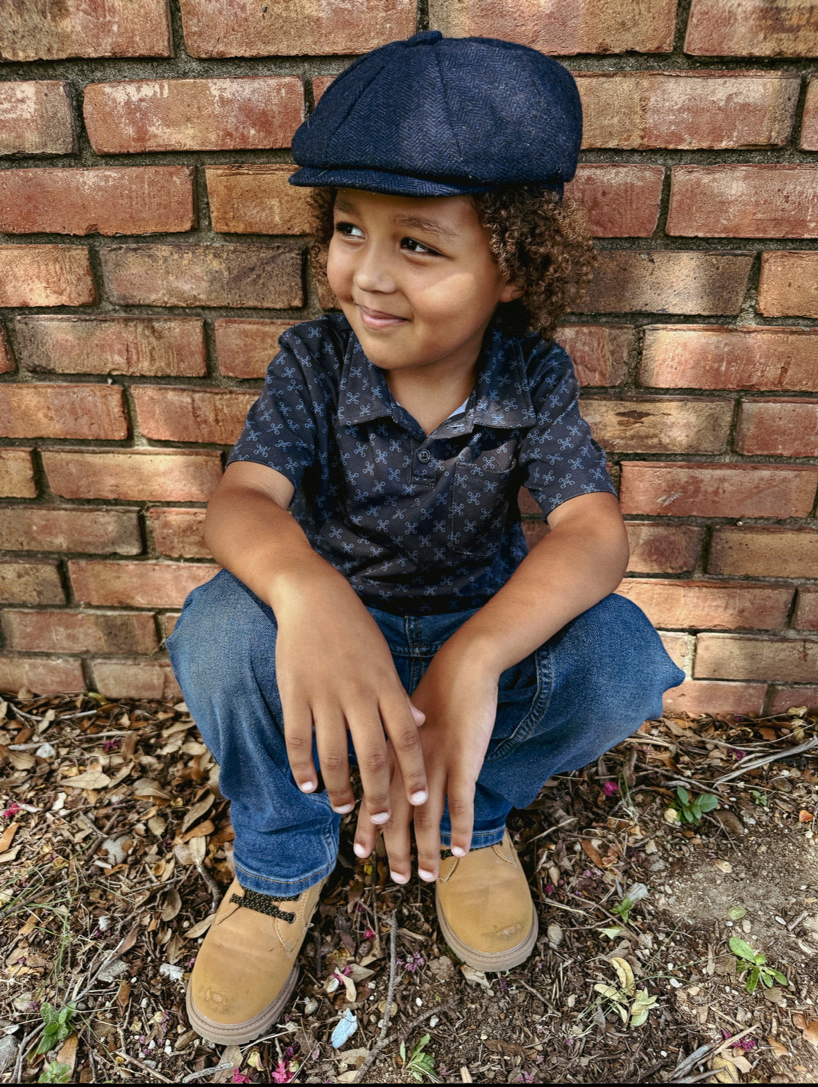 Young boy wearing a dark blue polo shirt