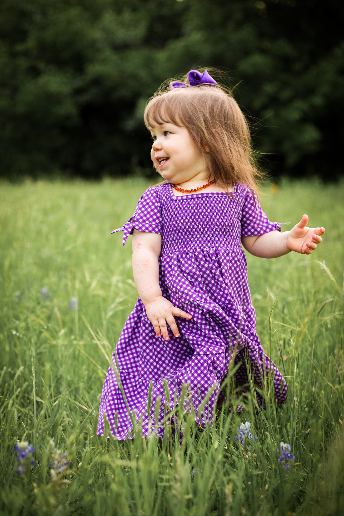 Young girl wearing a modest purple dress