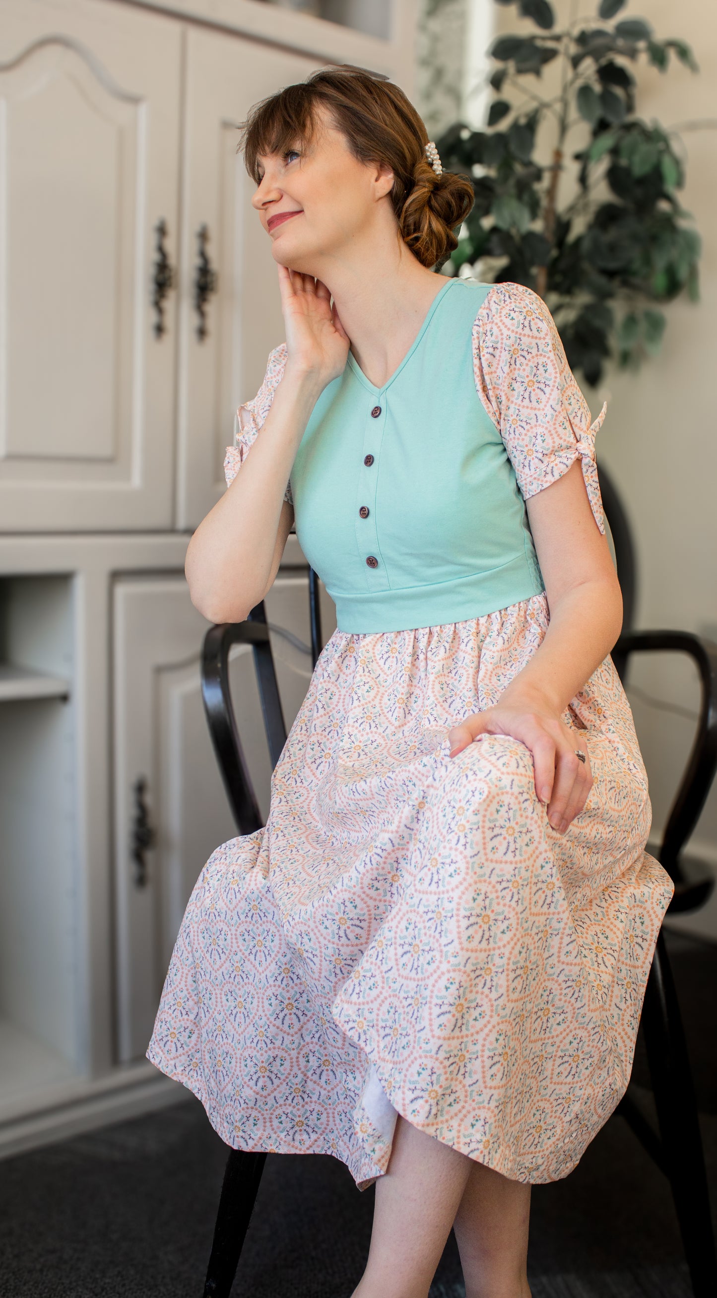 A woman wearing a vintage style modest nursing dress.
