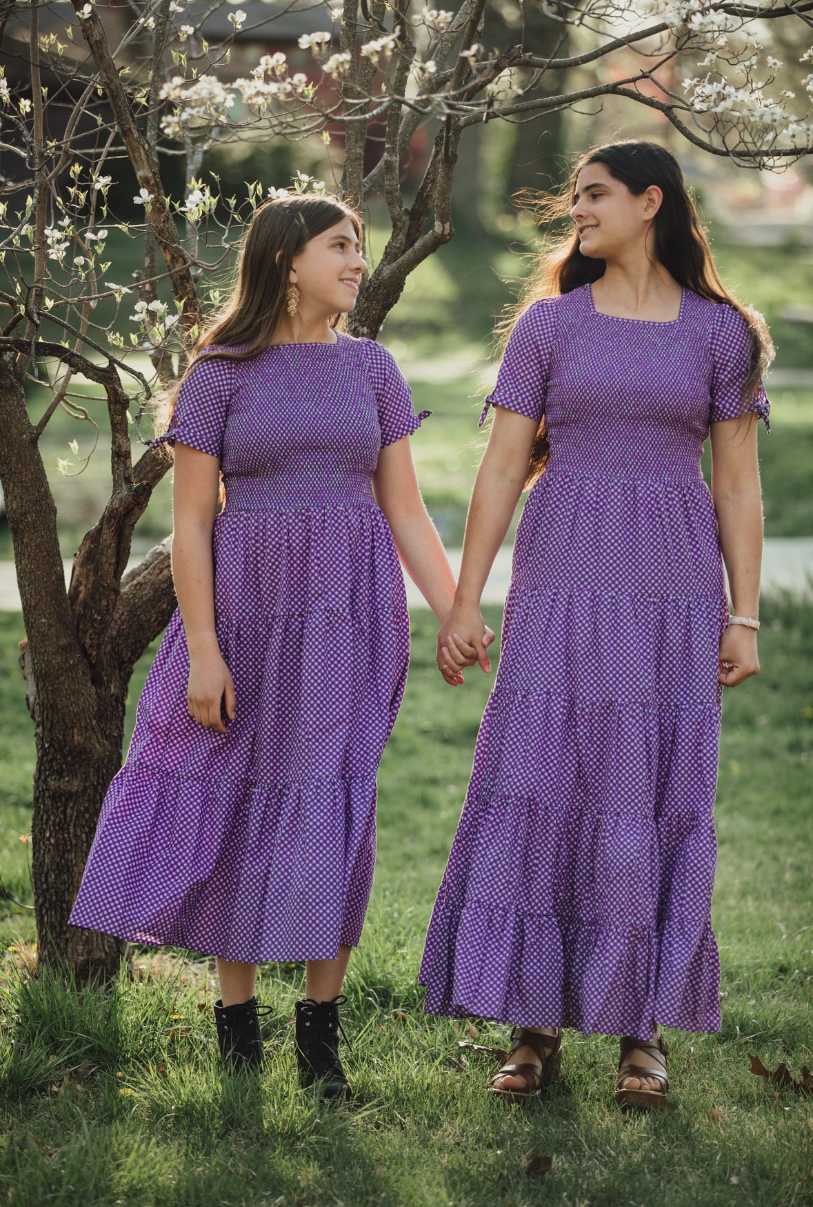 Young girls wearing modest purple dresses