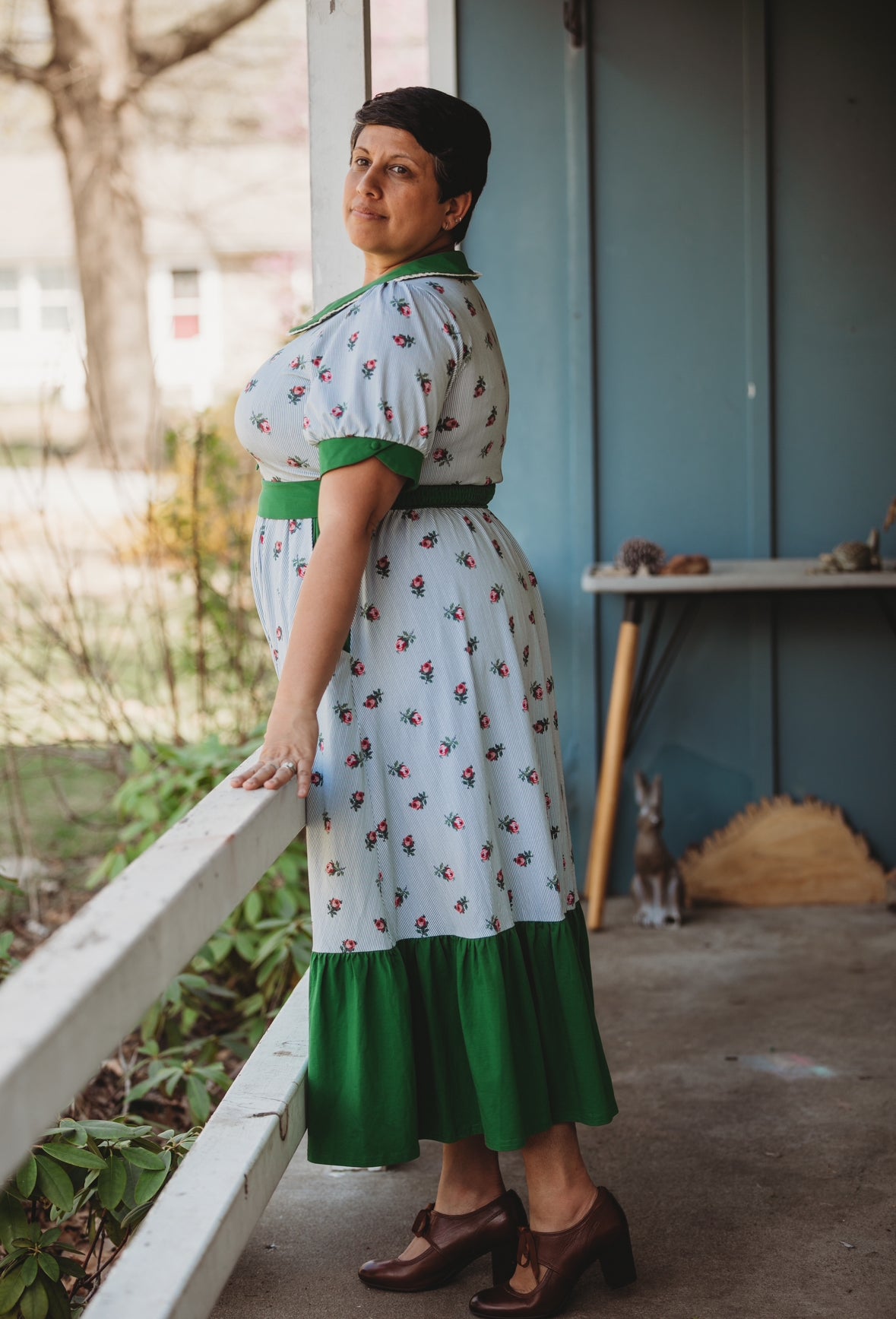 woman wearing a green and white striped modest nursing dress