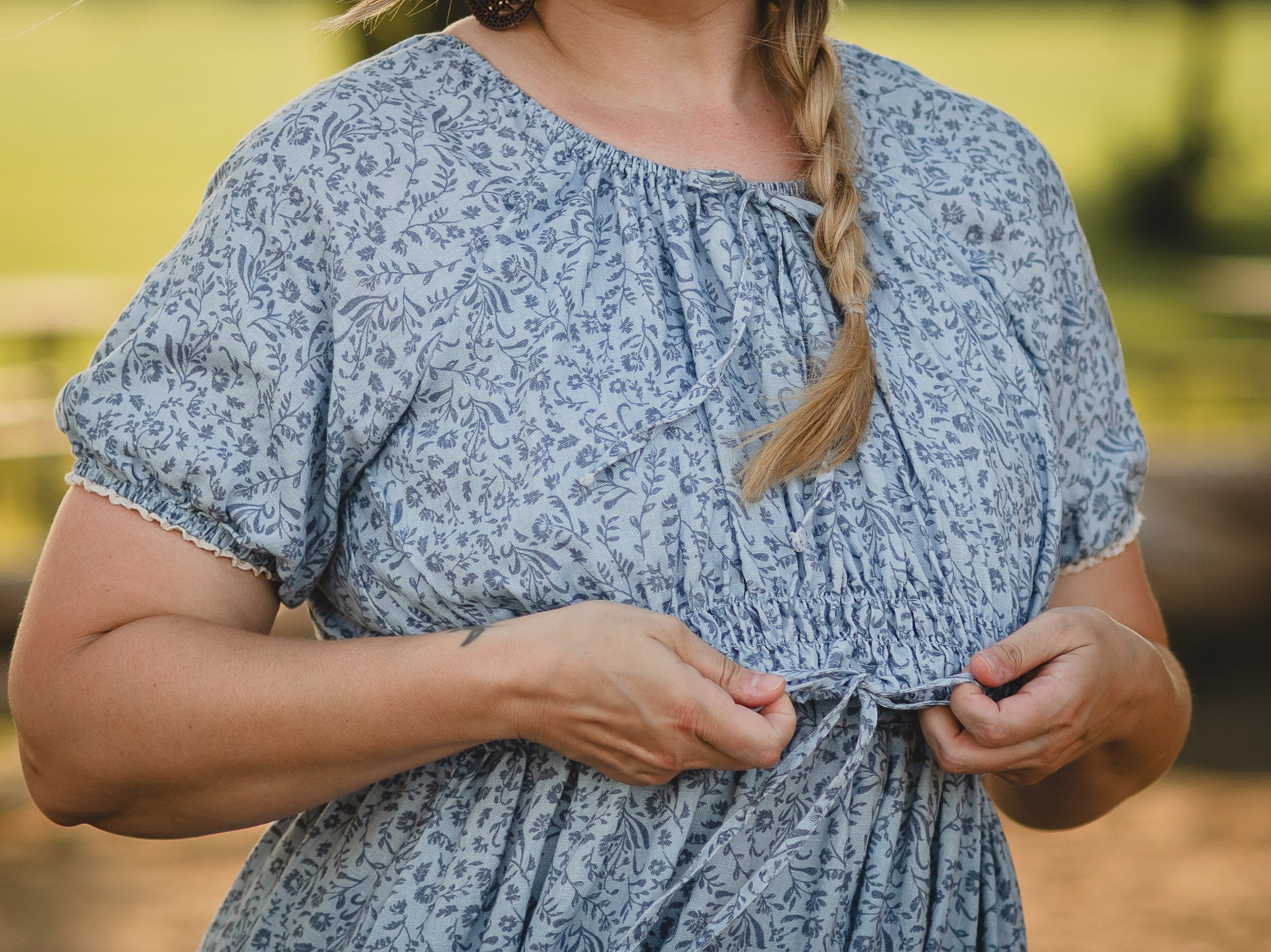 woman in a modest blue nursing dress