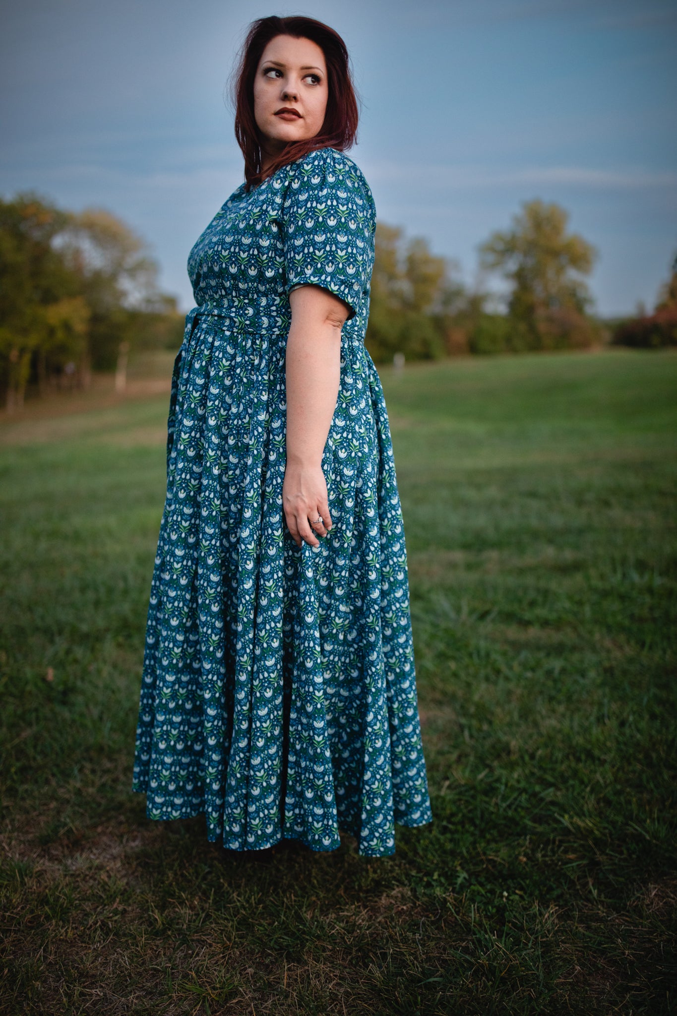 Woman in modest nursing dress in field