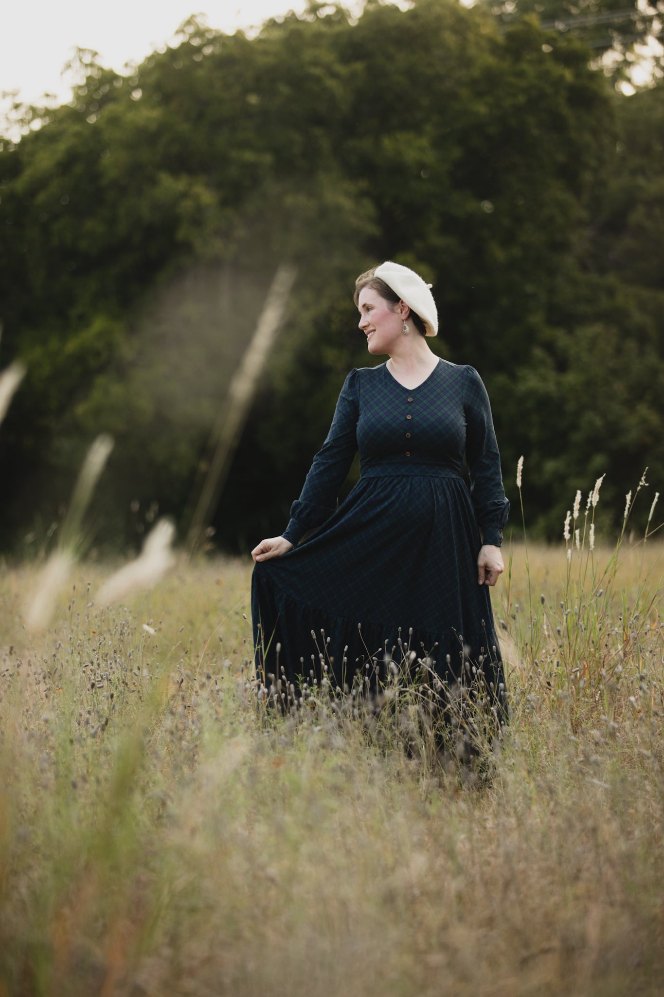 Woman in modest nursing dress with hat outdoors