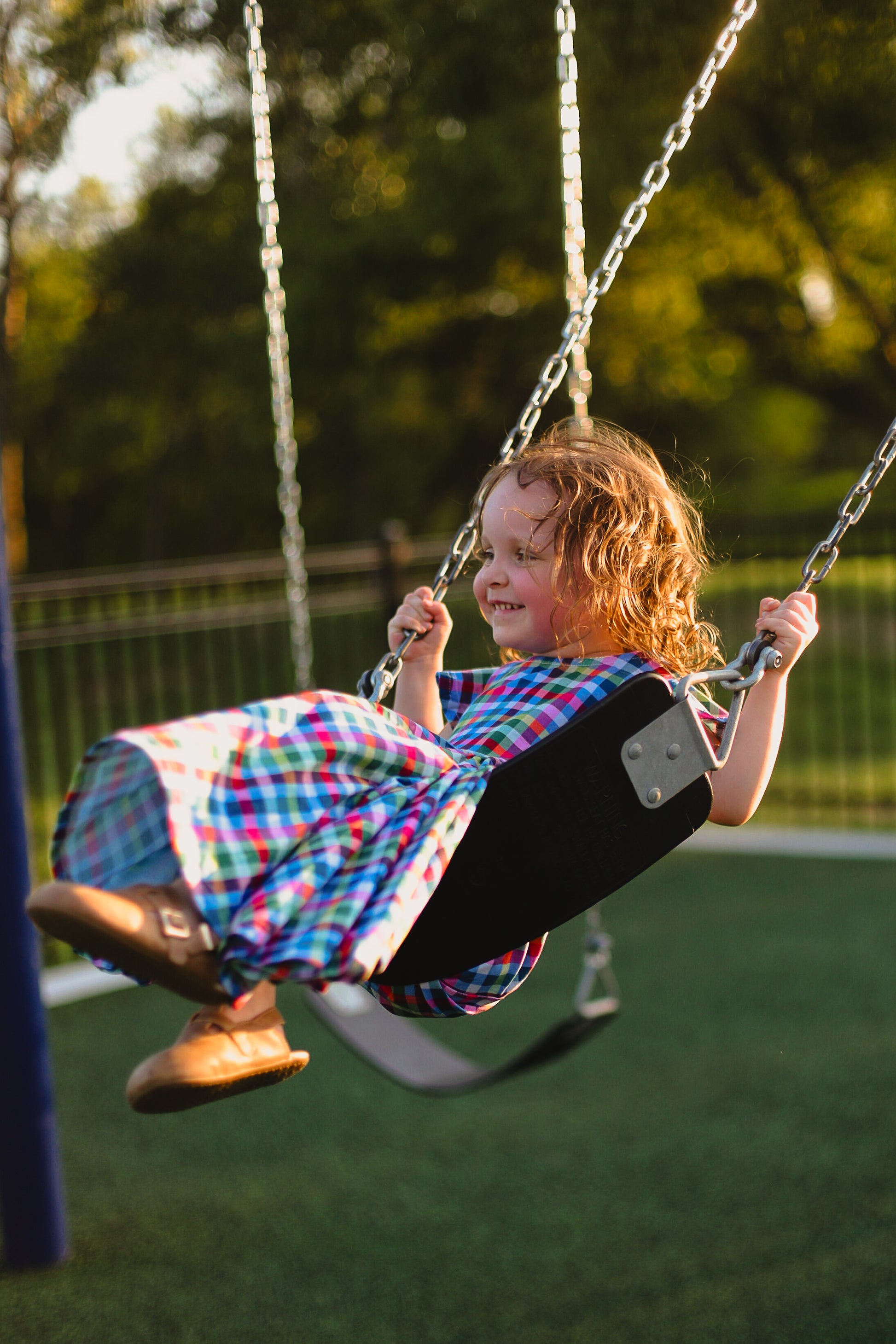 Young girl in a colorful checkered modest dress
