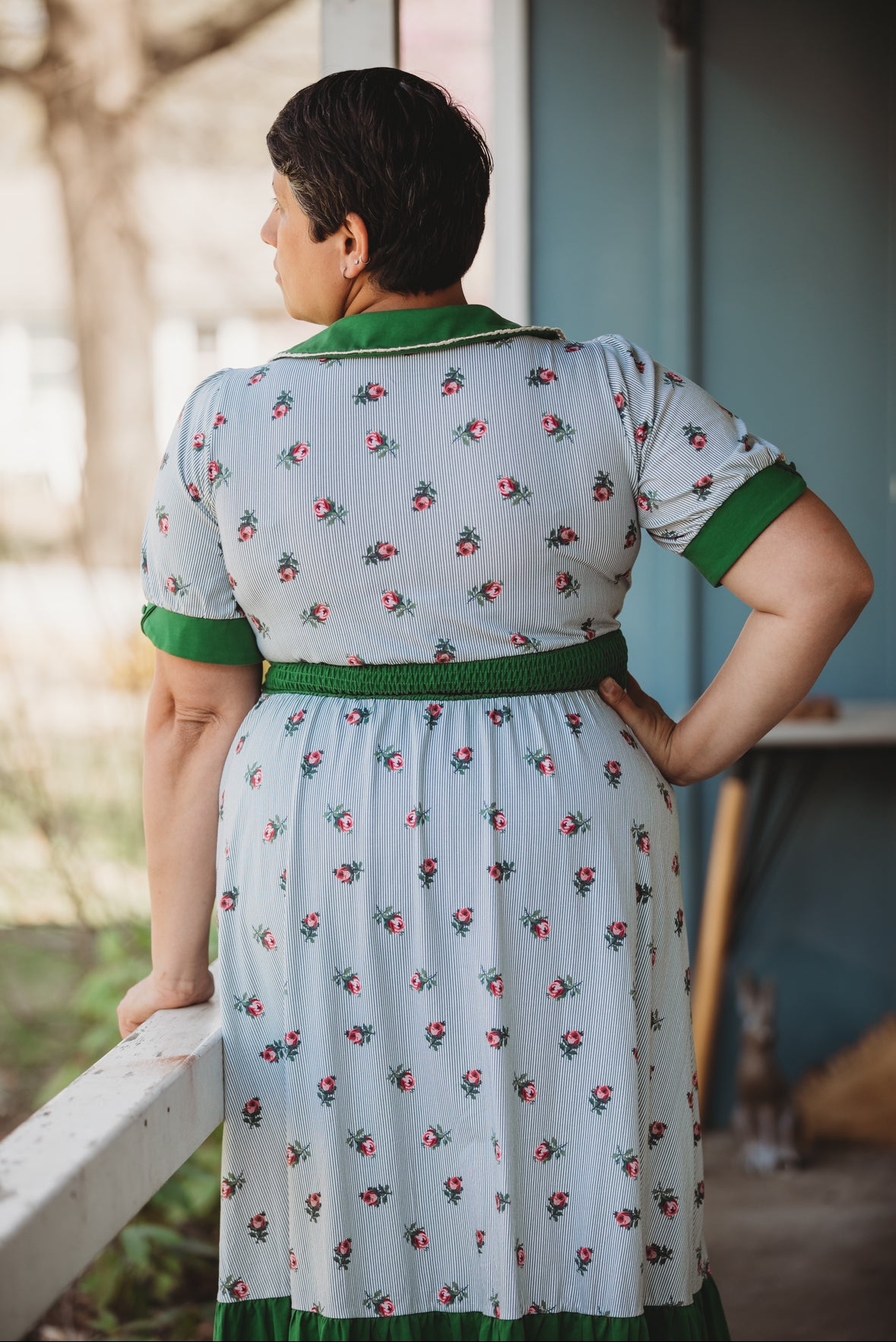 woman wearing a green and white striped modest nursing dress