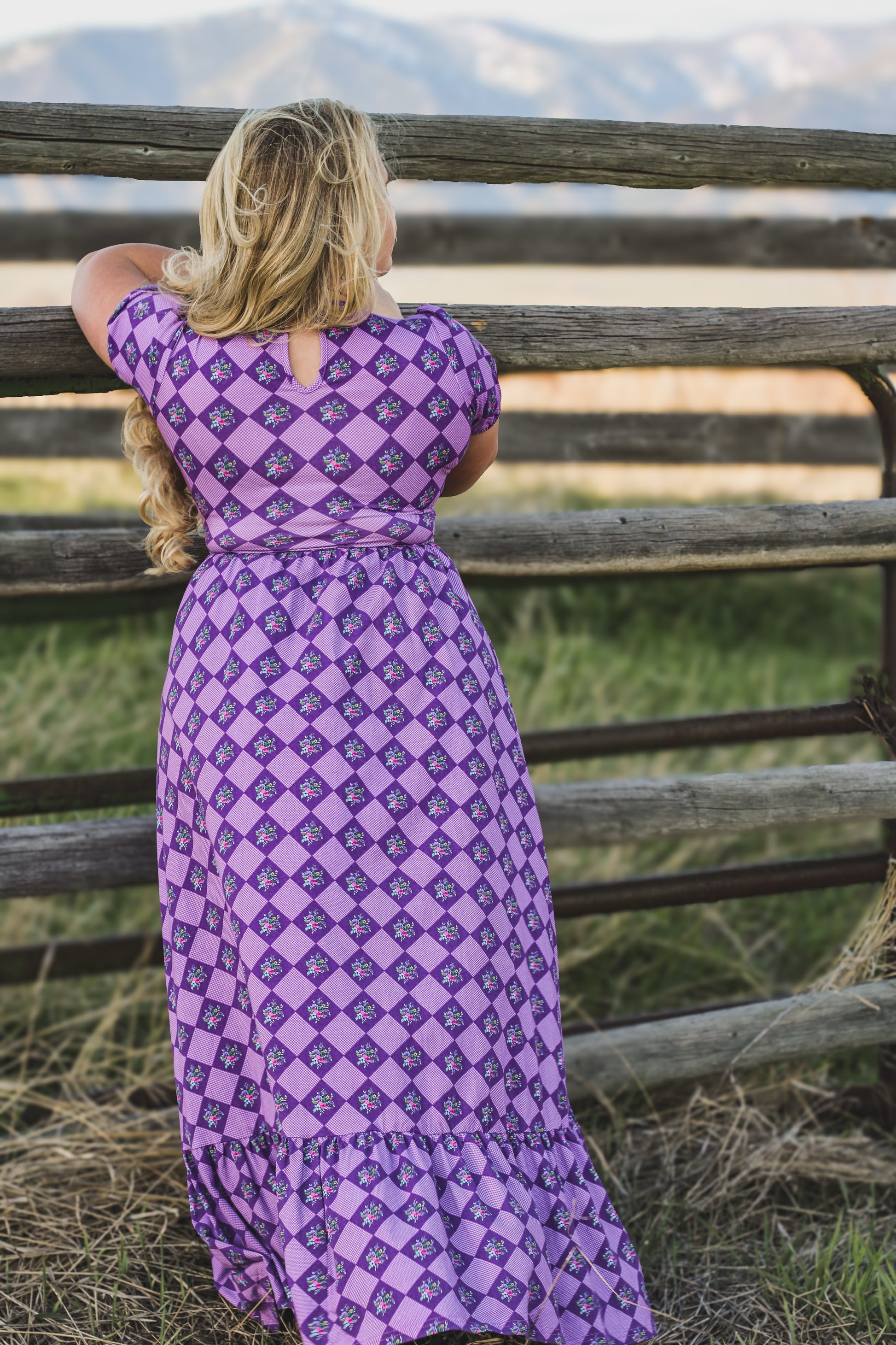 Woman in a purple checkered modest nursing dress.