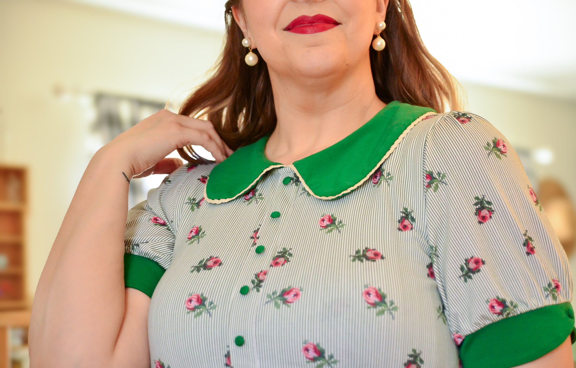 woman wearing a green and white striped modest nursing dress