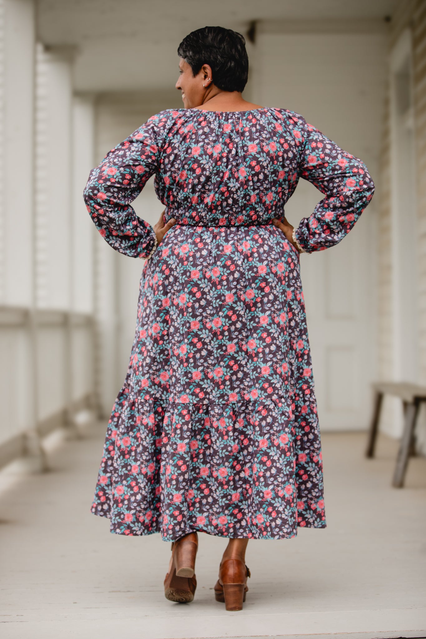 Woman in modest nursing floral dress on porch