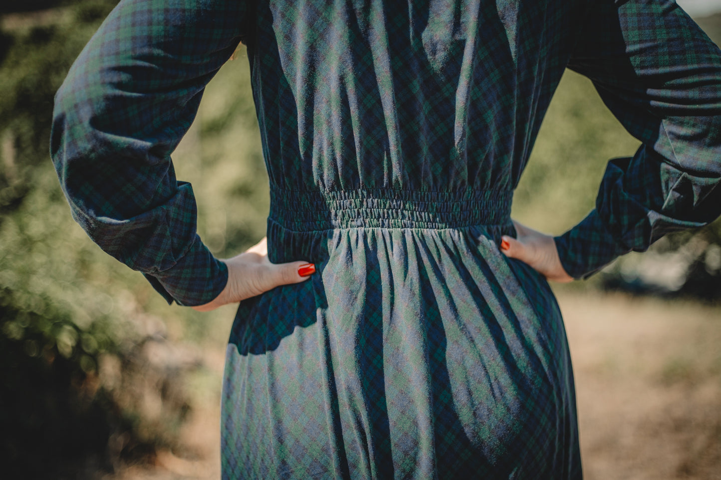 Woman in modest nursing plaid dress hands on hips