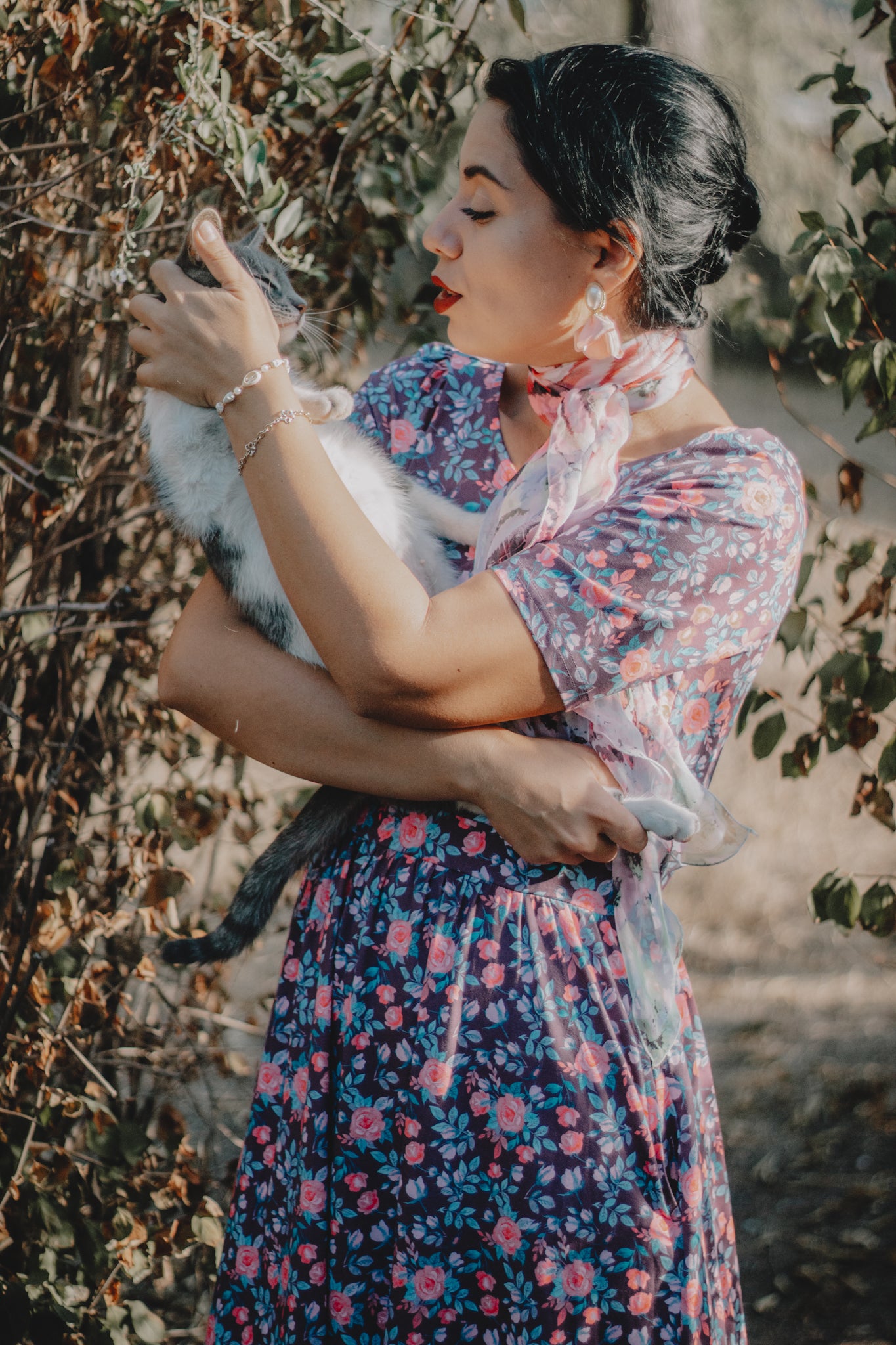 woman wearing a modest nursing floral dress with her cat