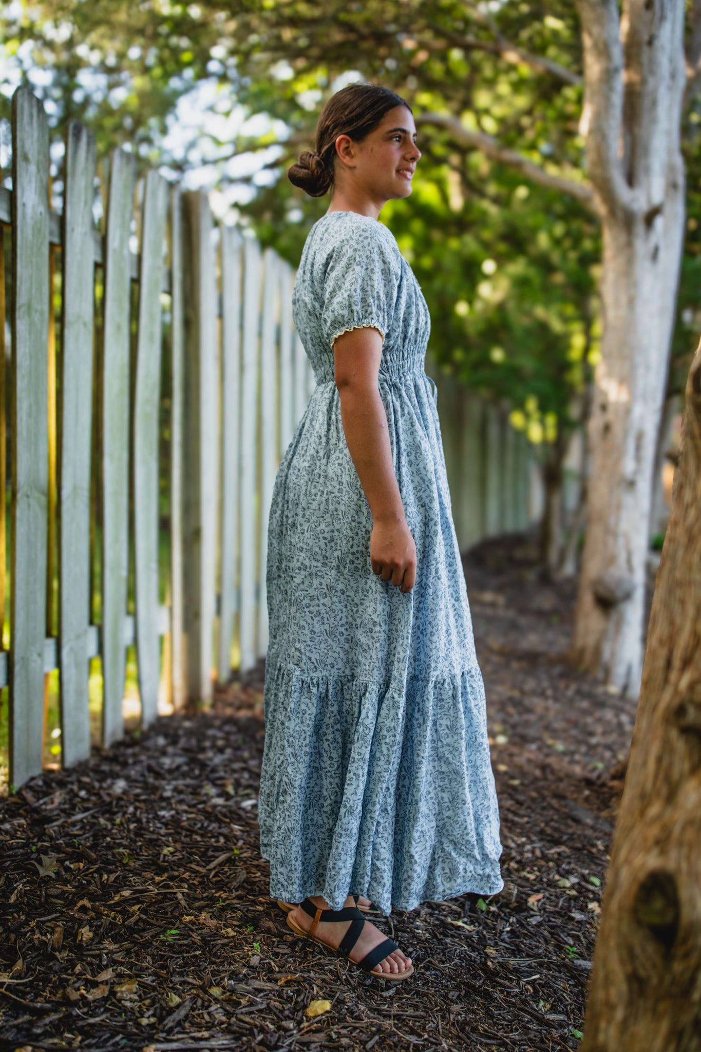 woman in a modest blue nursing dress