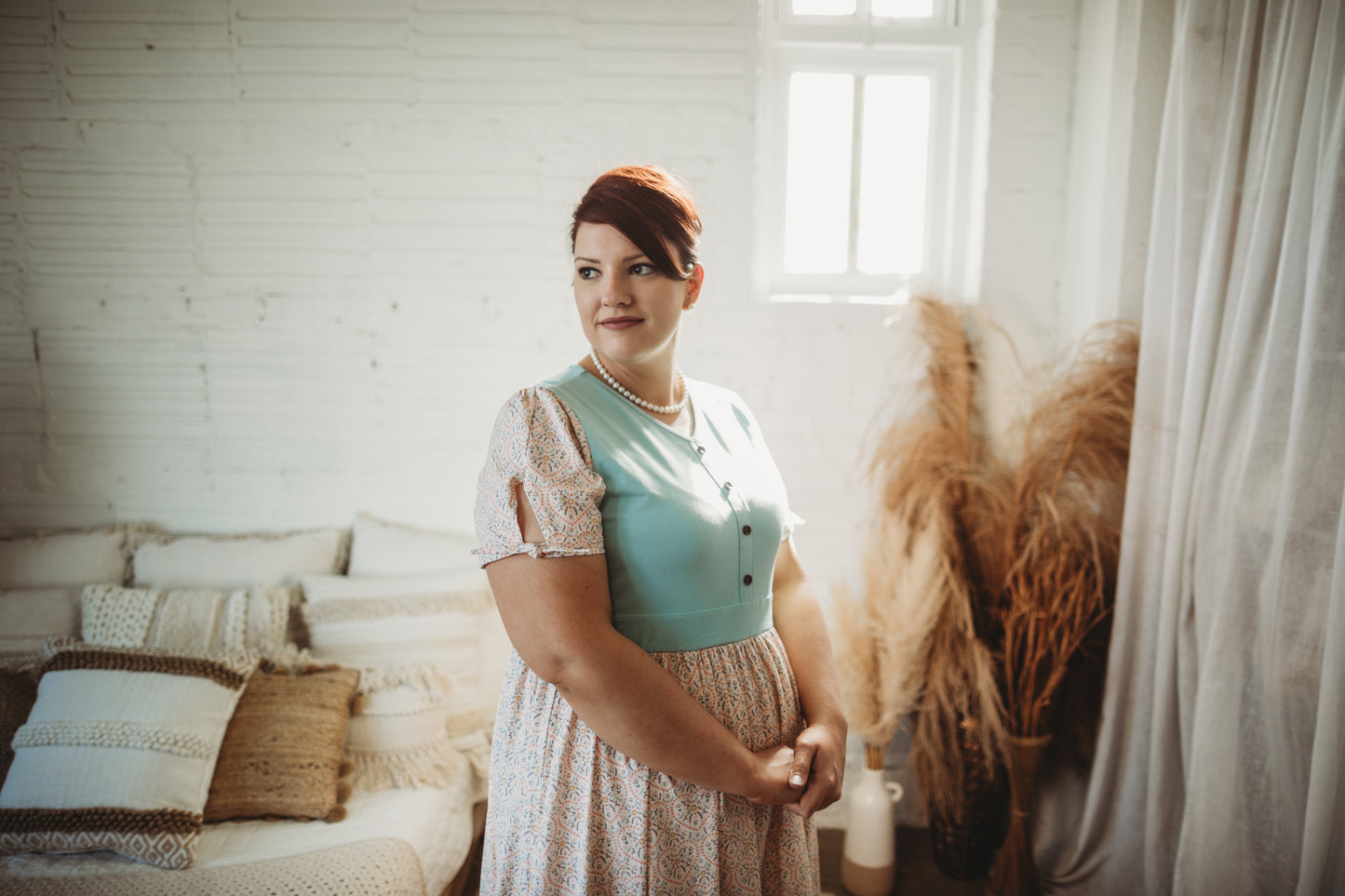 A woman wearing a vintage style modest nursing dress.