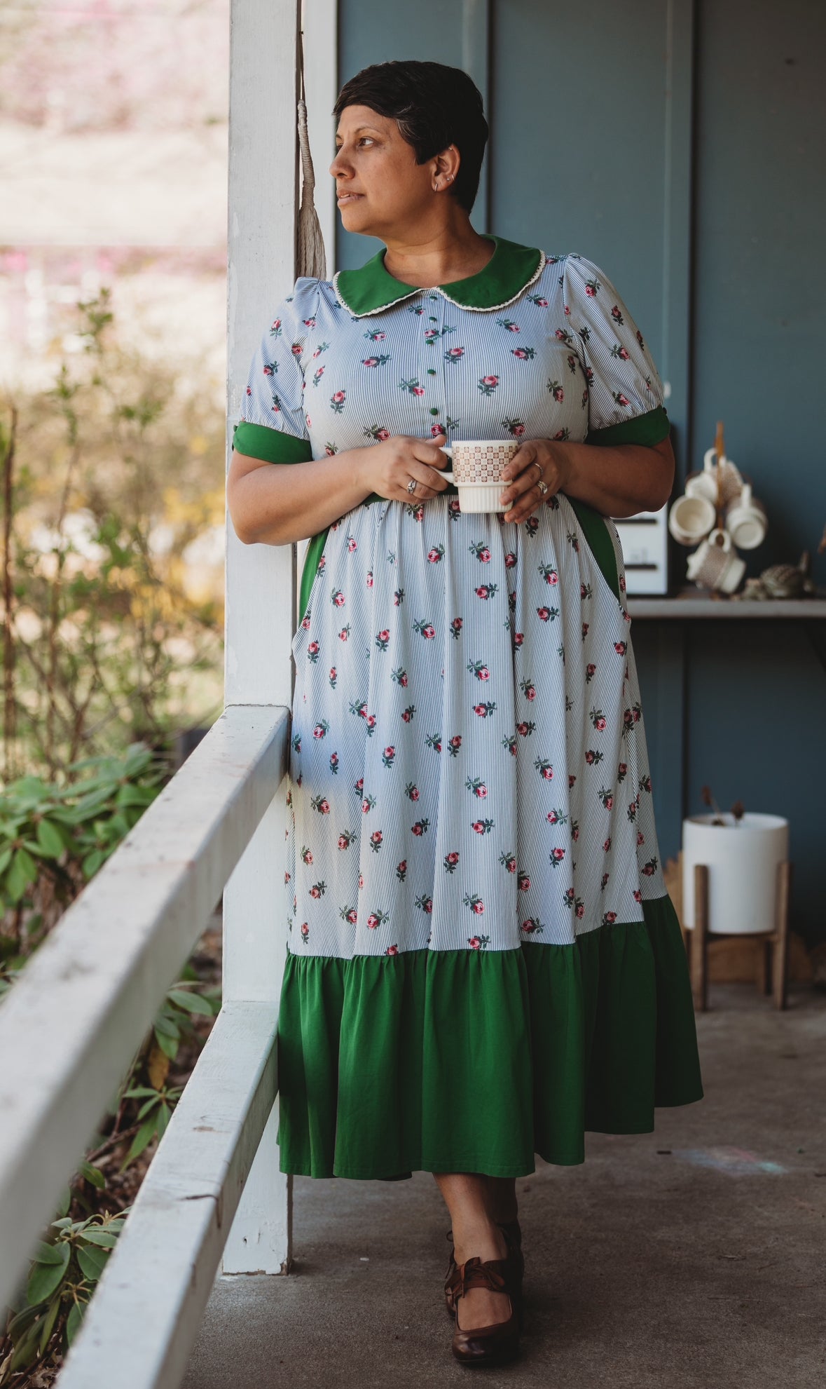 woman wearing a green and white striped modest nursing dress