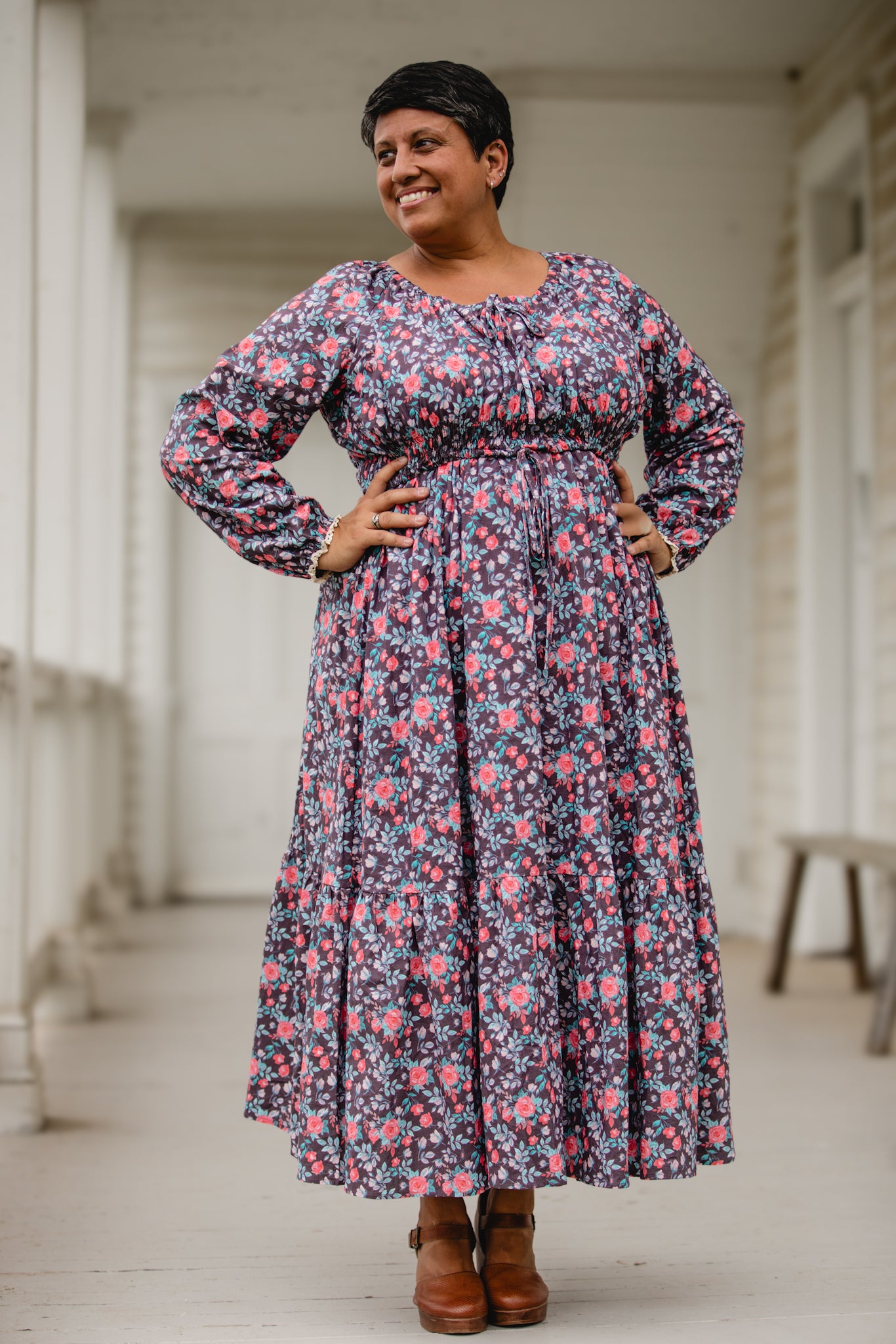 Woman in modest nursing dress on porch