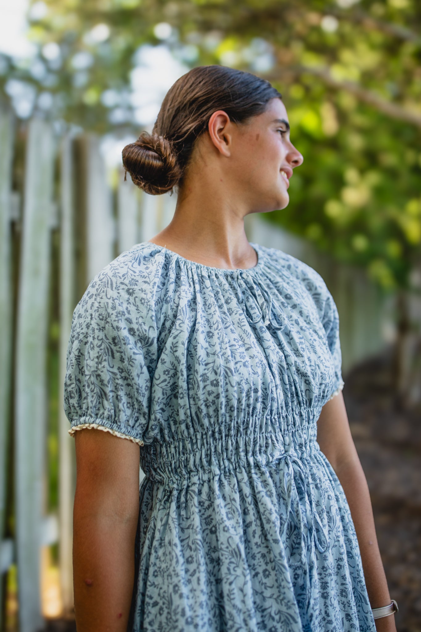 woman in a modest blue nursing dress