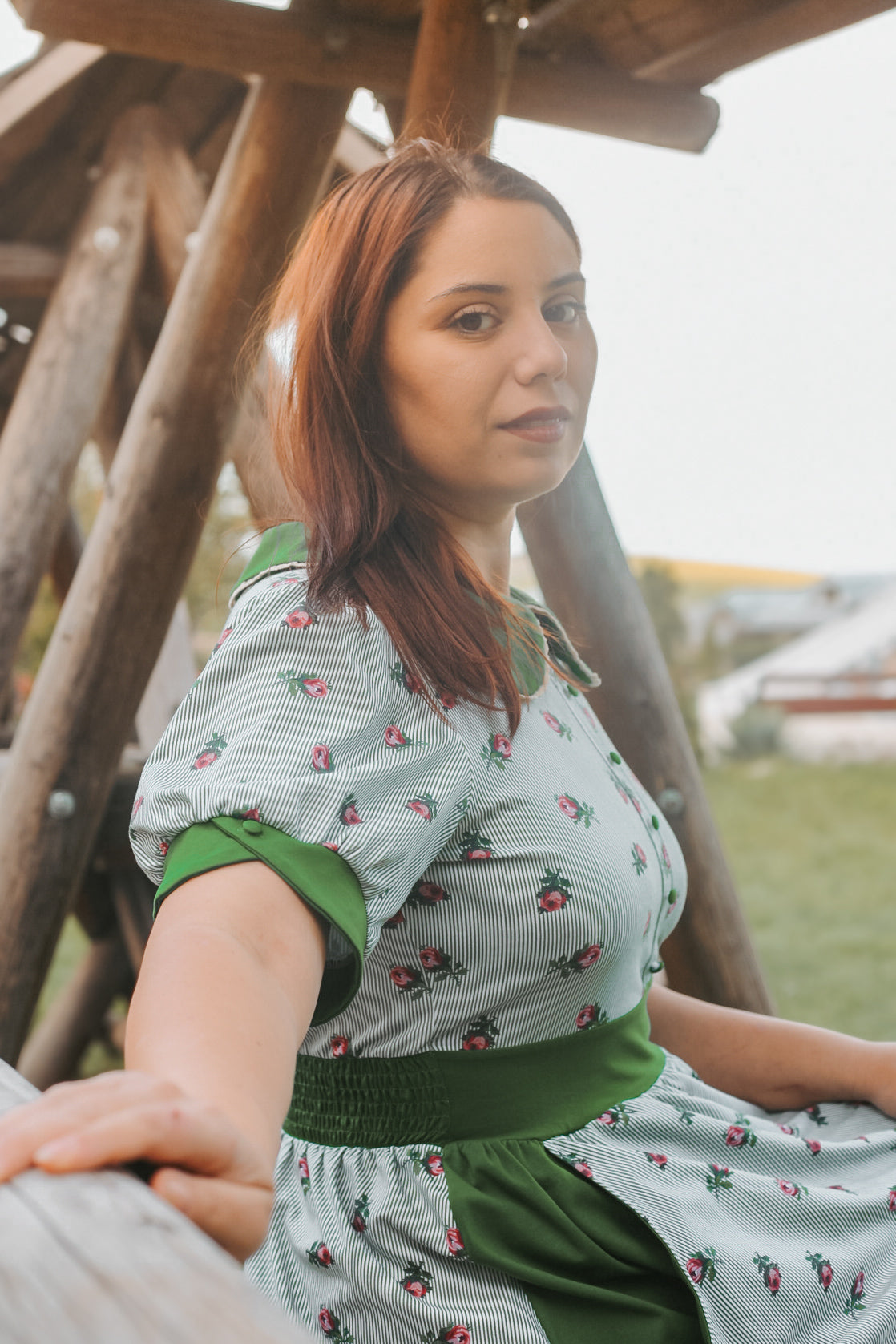 woman wearing a green and white striped modest nursing dress