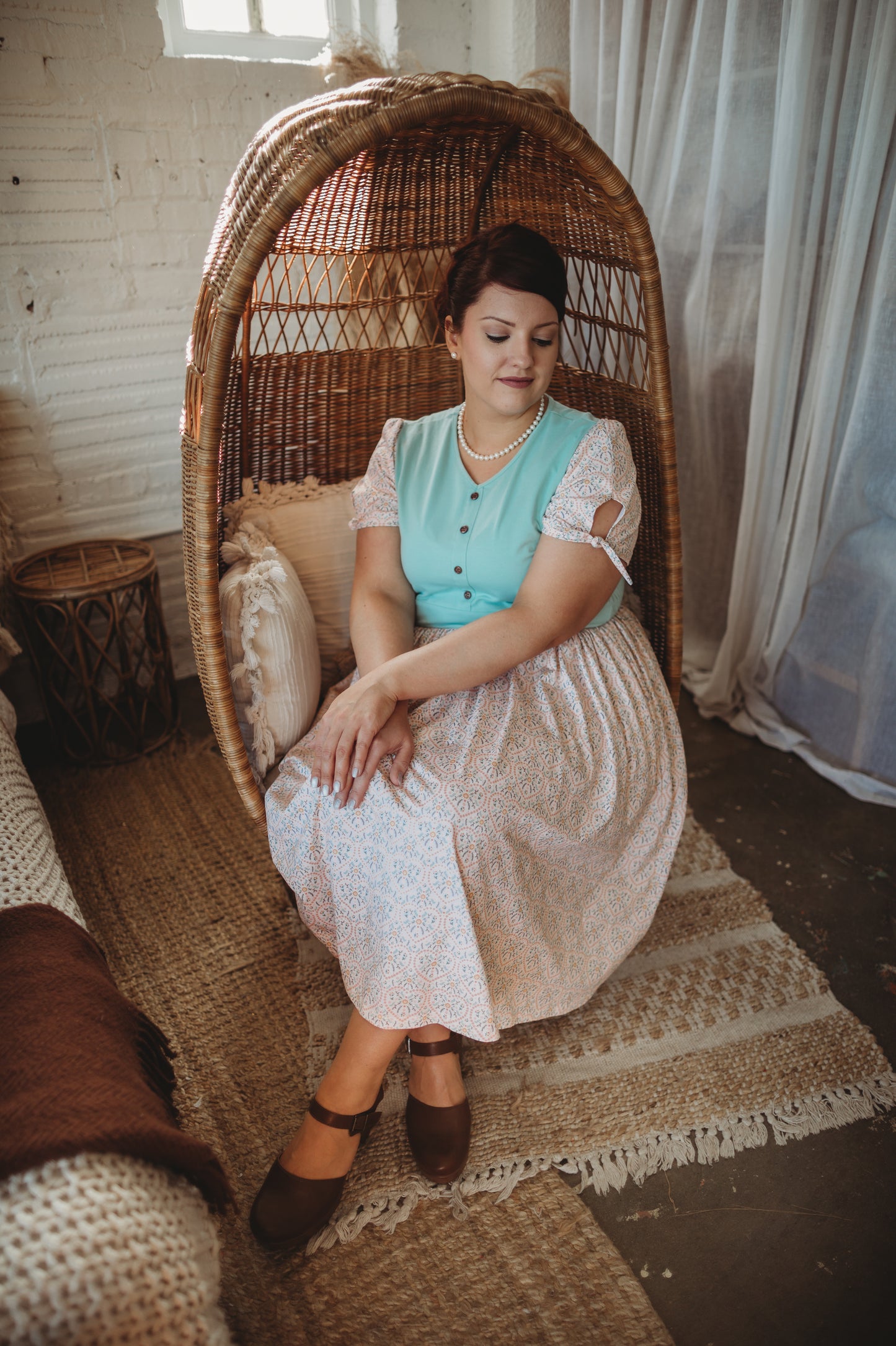 A woman wearing a vintage style modest nursing dress.