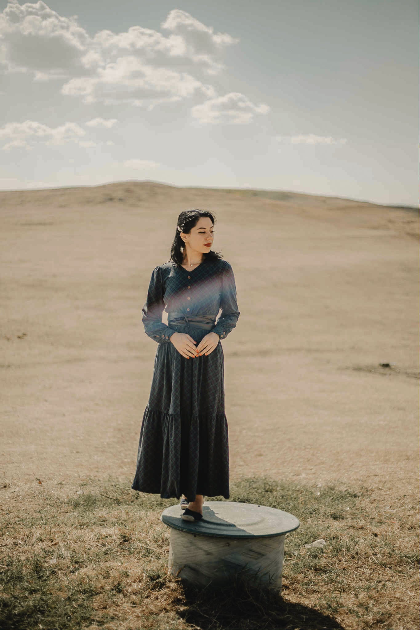 Woman in modest nursing dark dress field