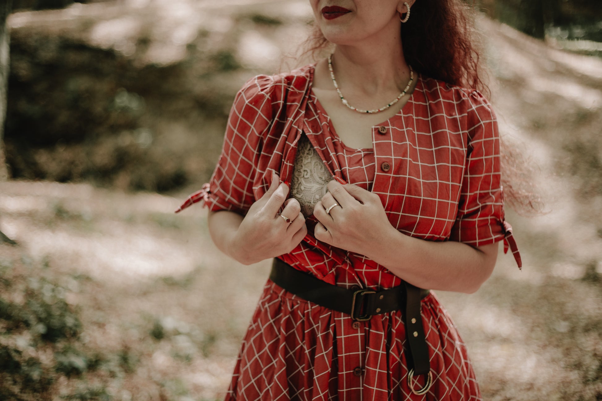Woman in modest nursing plaid dress holding heart