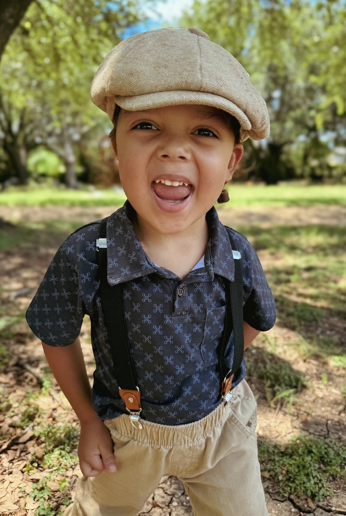 Young boy wearing a dark blue polo shirt