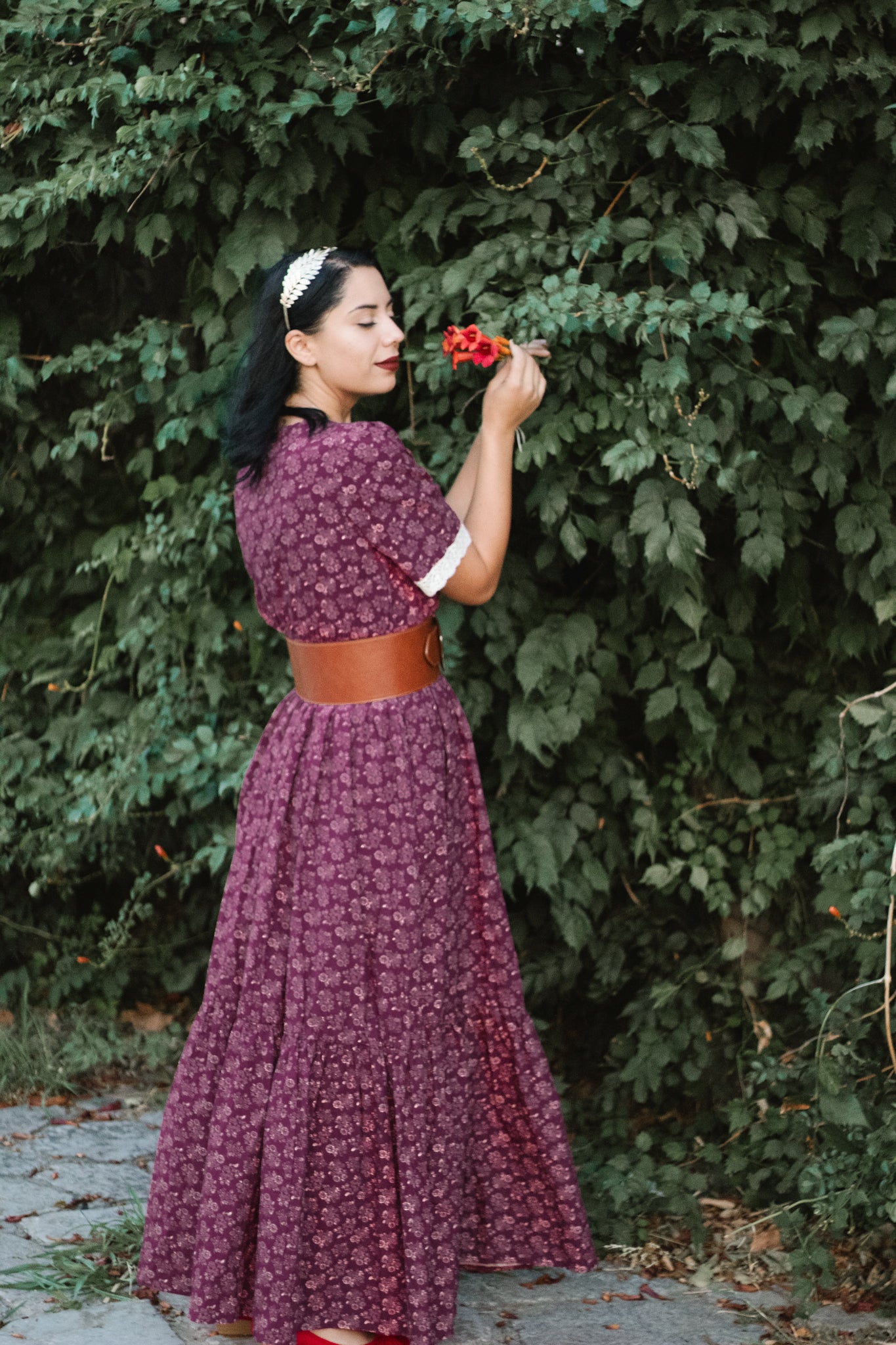 Woman in modest purple floral nursing dress outdoors