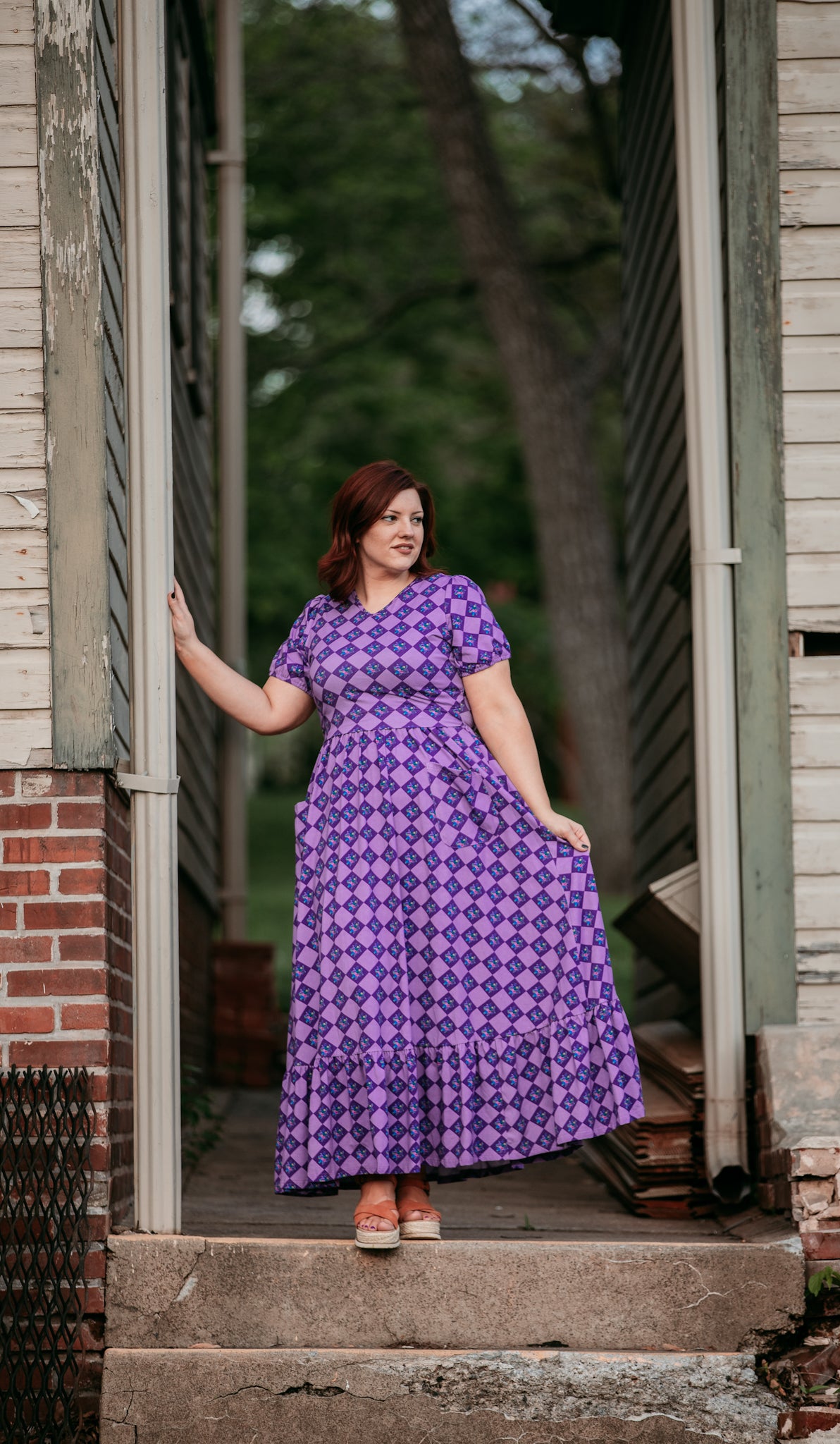 Woman in a purple checkered modest nursing dress.