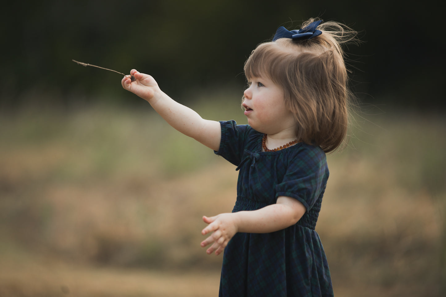Girl in modest dress playing outdoors