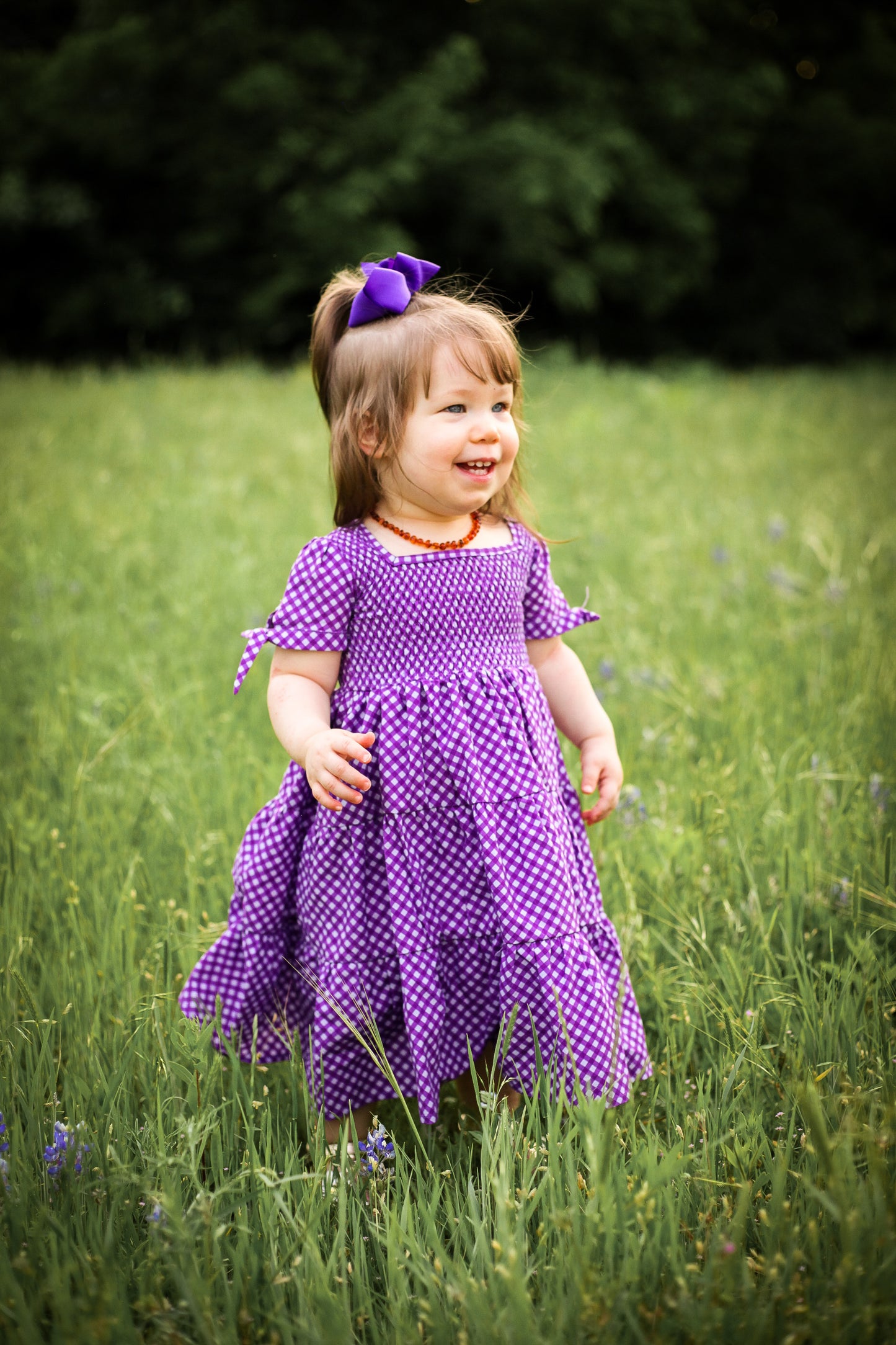 Young girl wearing a modest purple dress